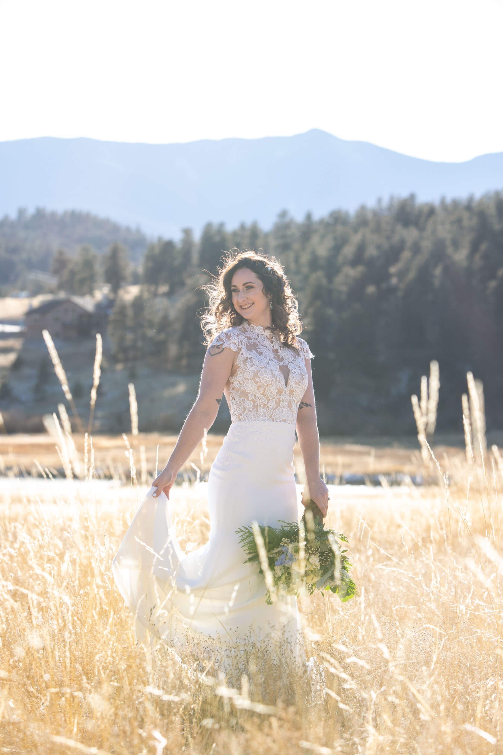 Bride in a field with mountain views