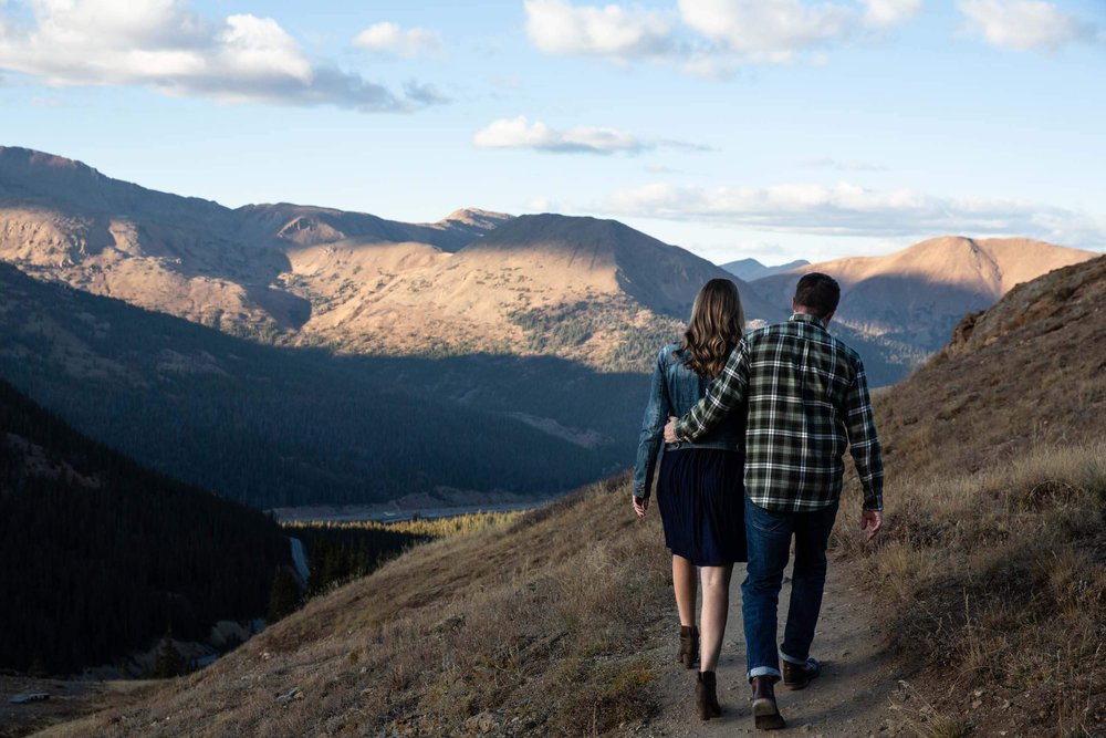 Couple walking away into the mountains in Colorado