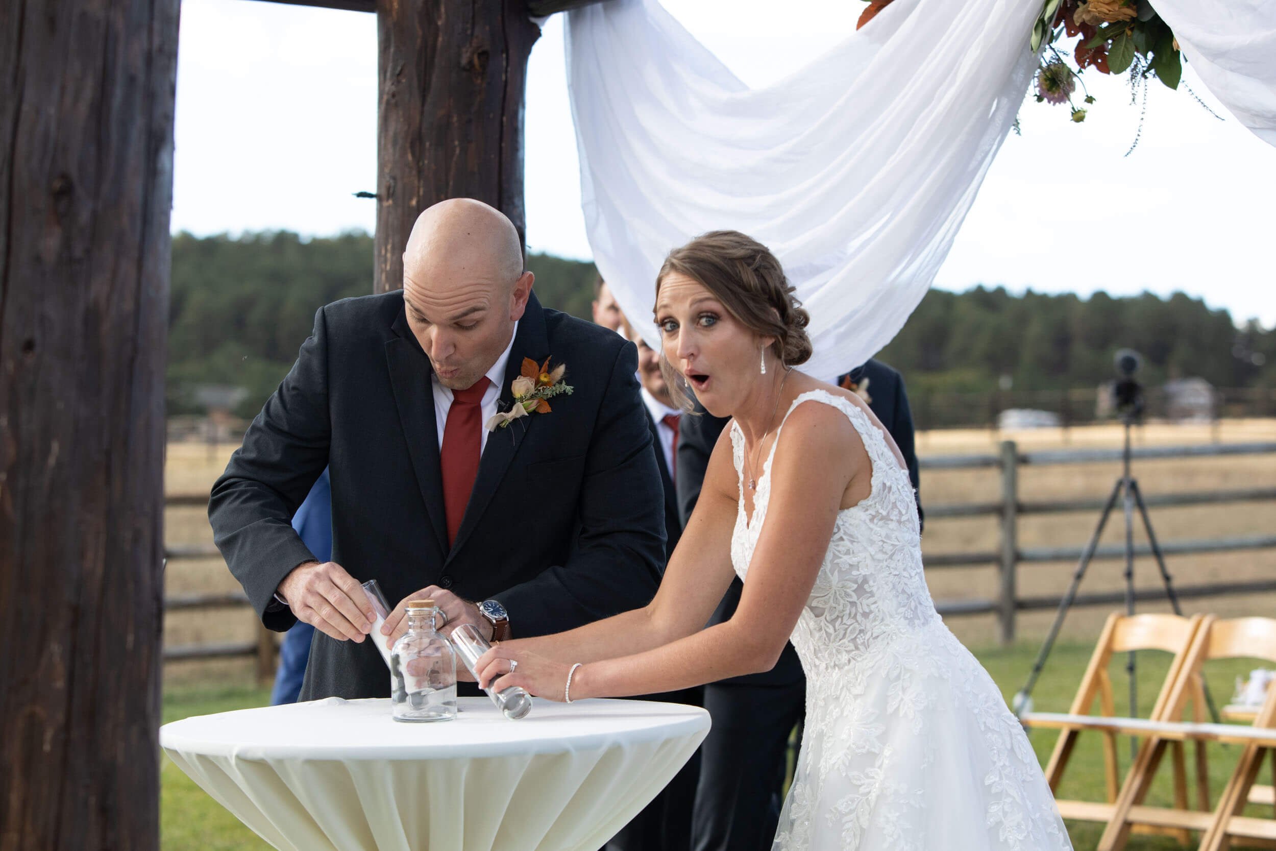 Couple Spilling the unity sand during ceremony in Colorado by CliftonMarie Photography