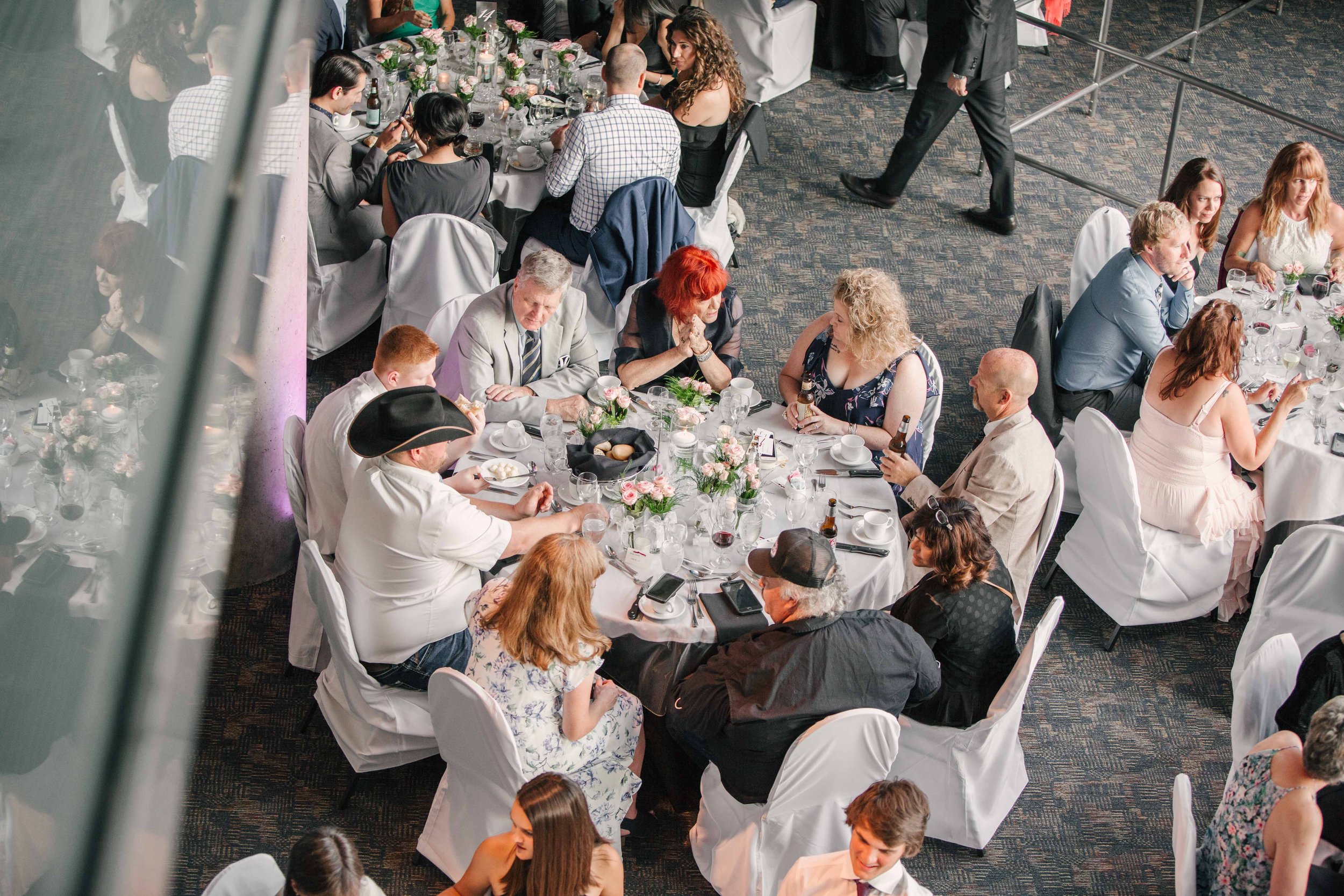 People seated at round tables during a formal event or banquet.