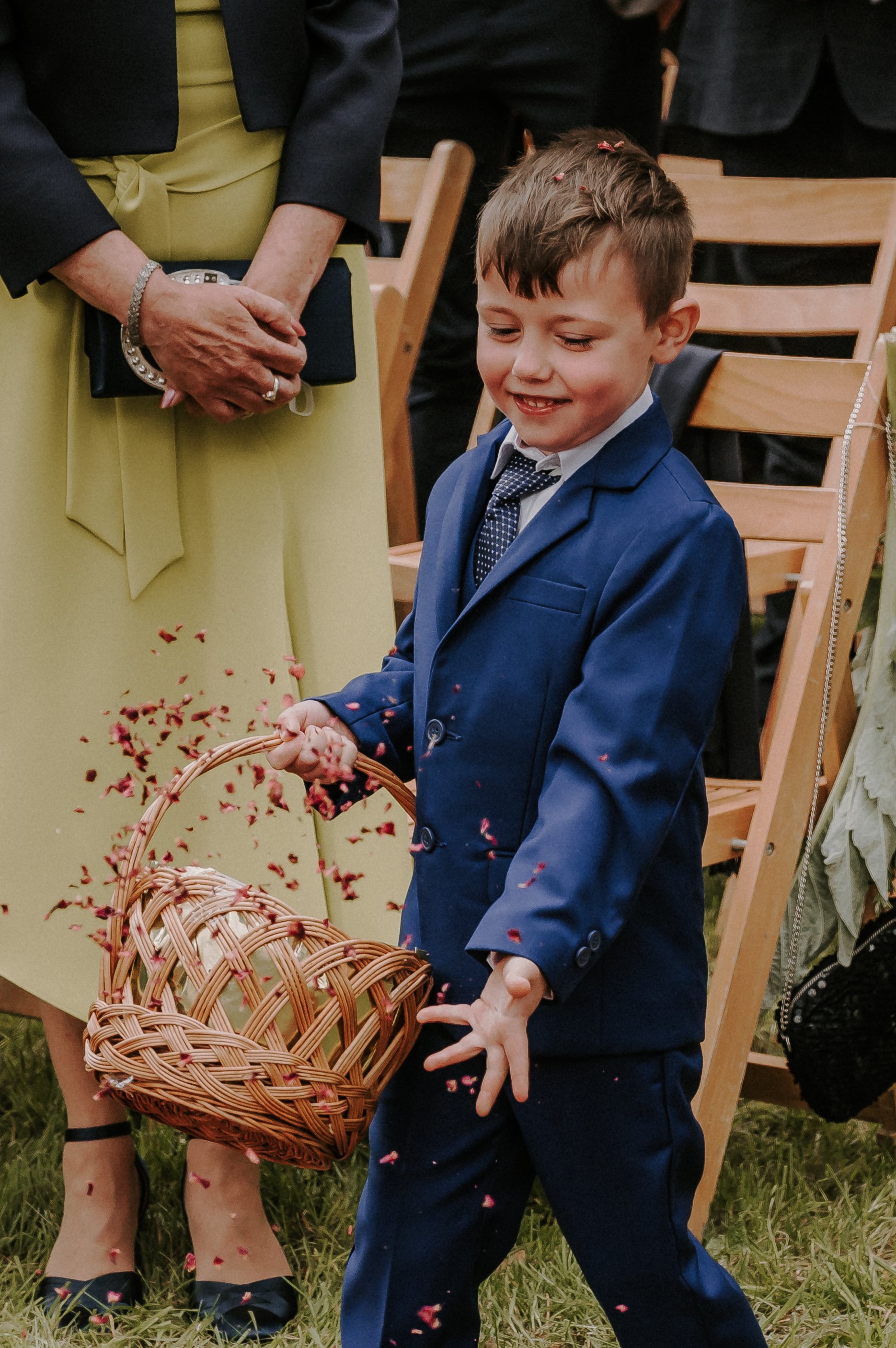 A Sweet Little Pageboy Proudly Spreads Rose Petals Down a Vintage Rug-Lined Aisle ahead of the Bridal Procession at Happy Valley Norfolk