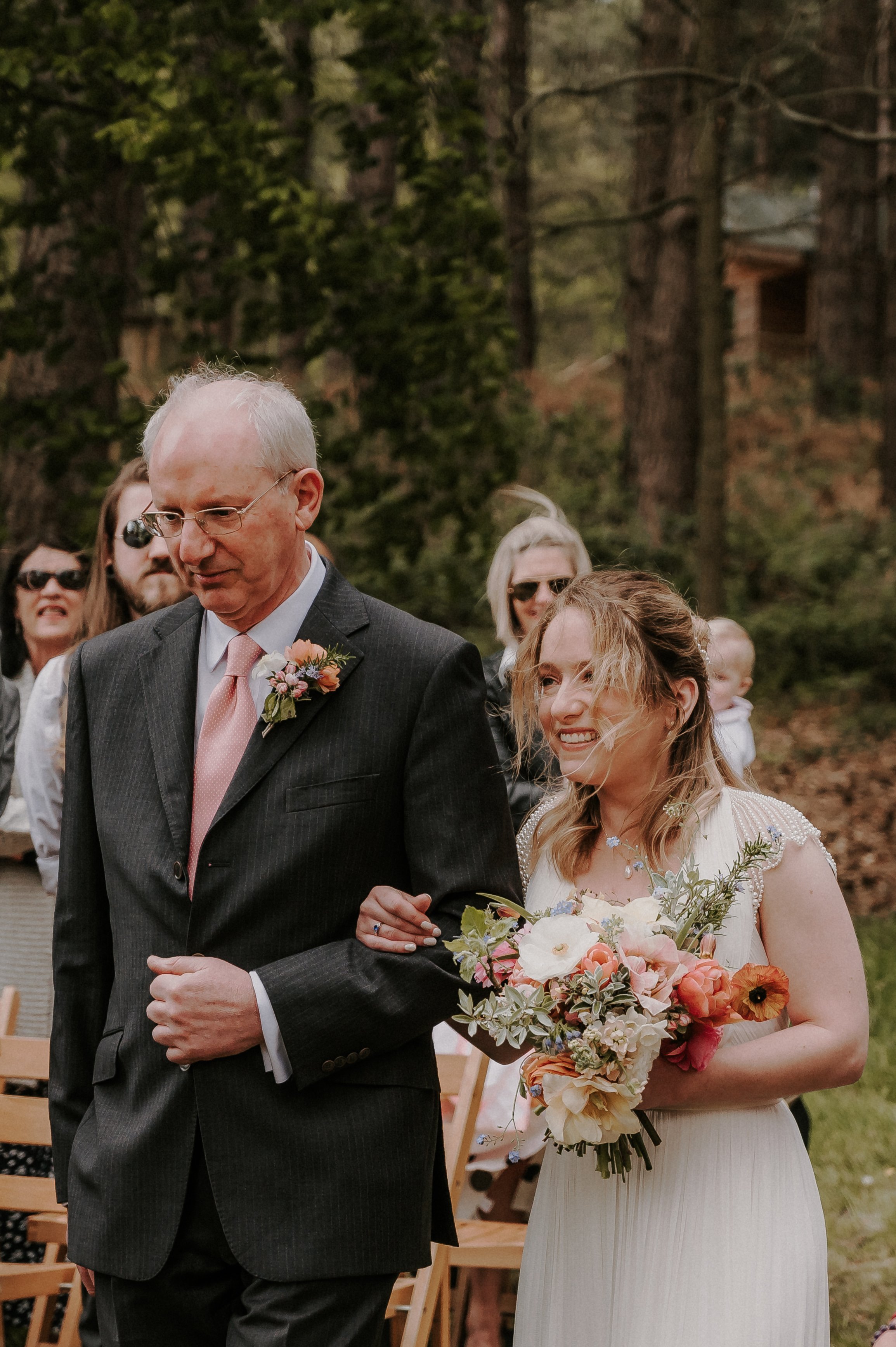 A heartfelt moment as a bride walks the aisle arm-in-arm with her Father