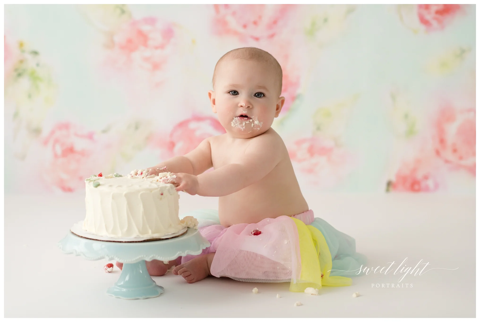First birthday photography with Maine & NH baby photographer Sweet Light Portraits. i year old baby girl enjoys her cake smash photo session!