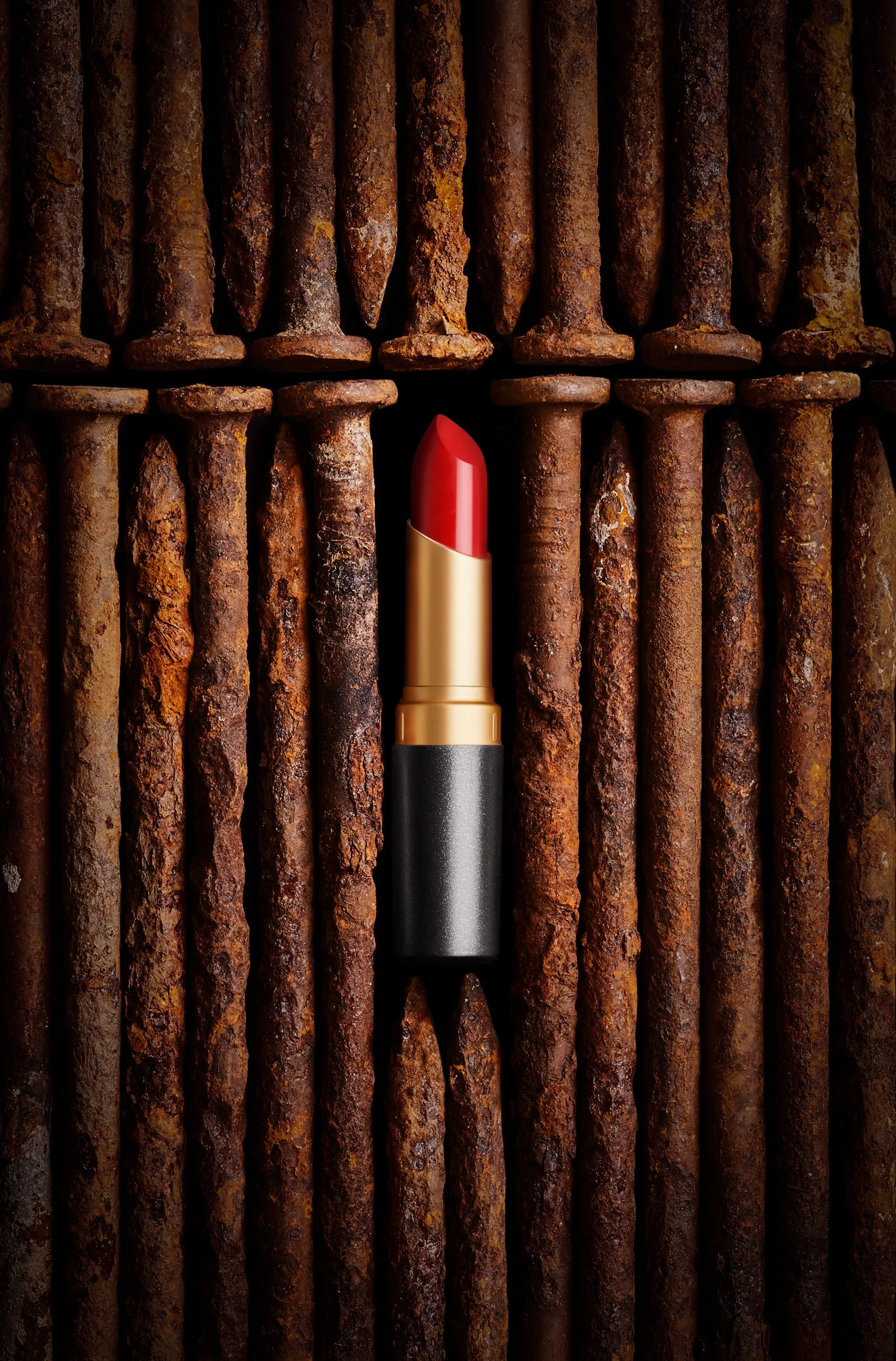 Adam Krauth Photo - Commercial Photography - Boston, MA - Still Life - Product Photography - Red lipstick in a sea of rusty railroad spikes. Cosmetics photography 
