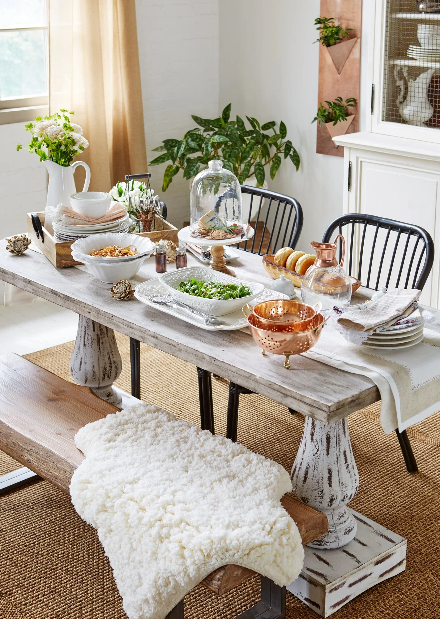 Adam Krauth Photo - Commercial Photography - Boston, MA - Still life - Interior photography. A scene of a rustic wooden dining table set with dishes, glassware, and decorative items. 