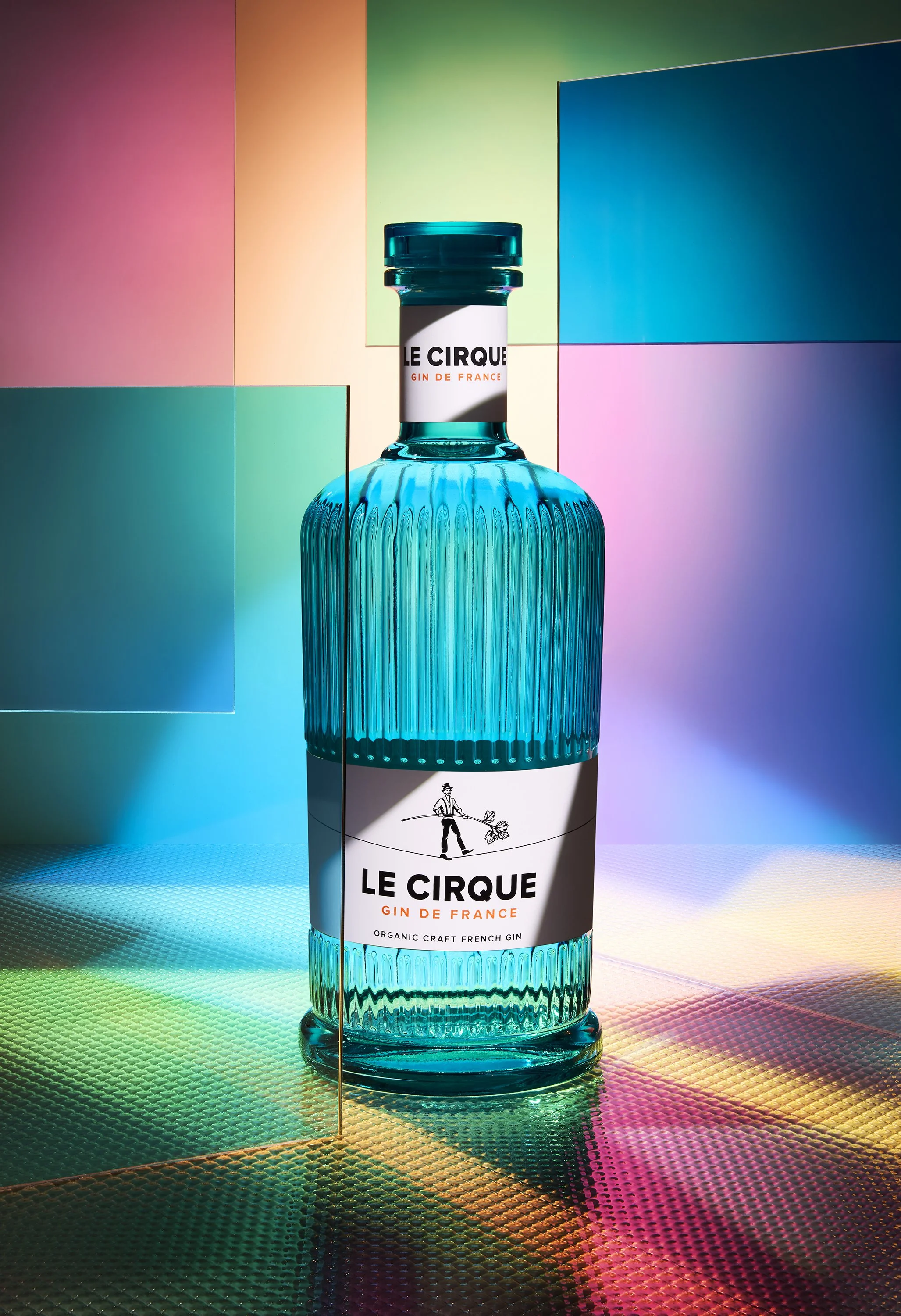 Adam Krauth Photo - Commercial Photography - Boston, MA - Still Life - Product Photography - Le Cirque organic gin in a blue fluted glass bottle in a scene with vibrant rainbow colors.  