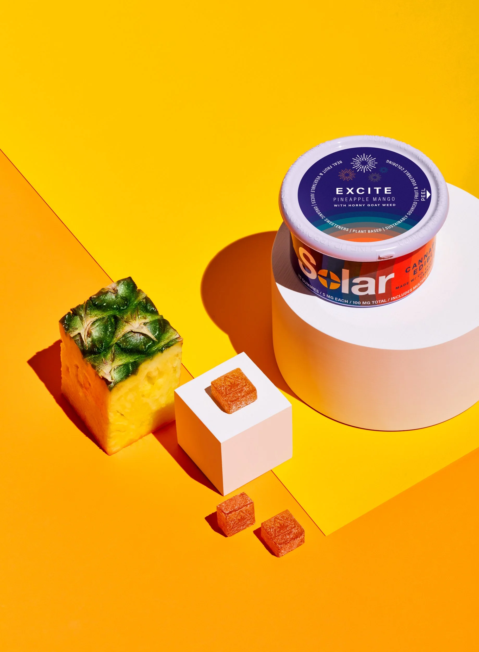 Adam Krauth Photo - Commercial Photography - Boston, MA - Still life - Product - Cannabis edibles. A colorful, geometric composition. Solar gummies. A vibrant split background of yellow and orange.