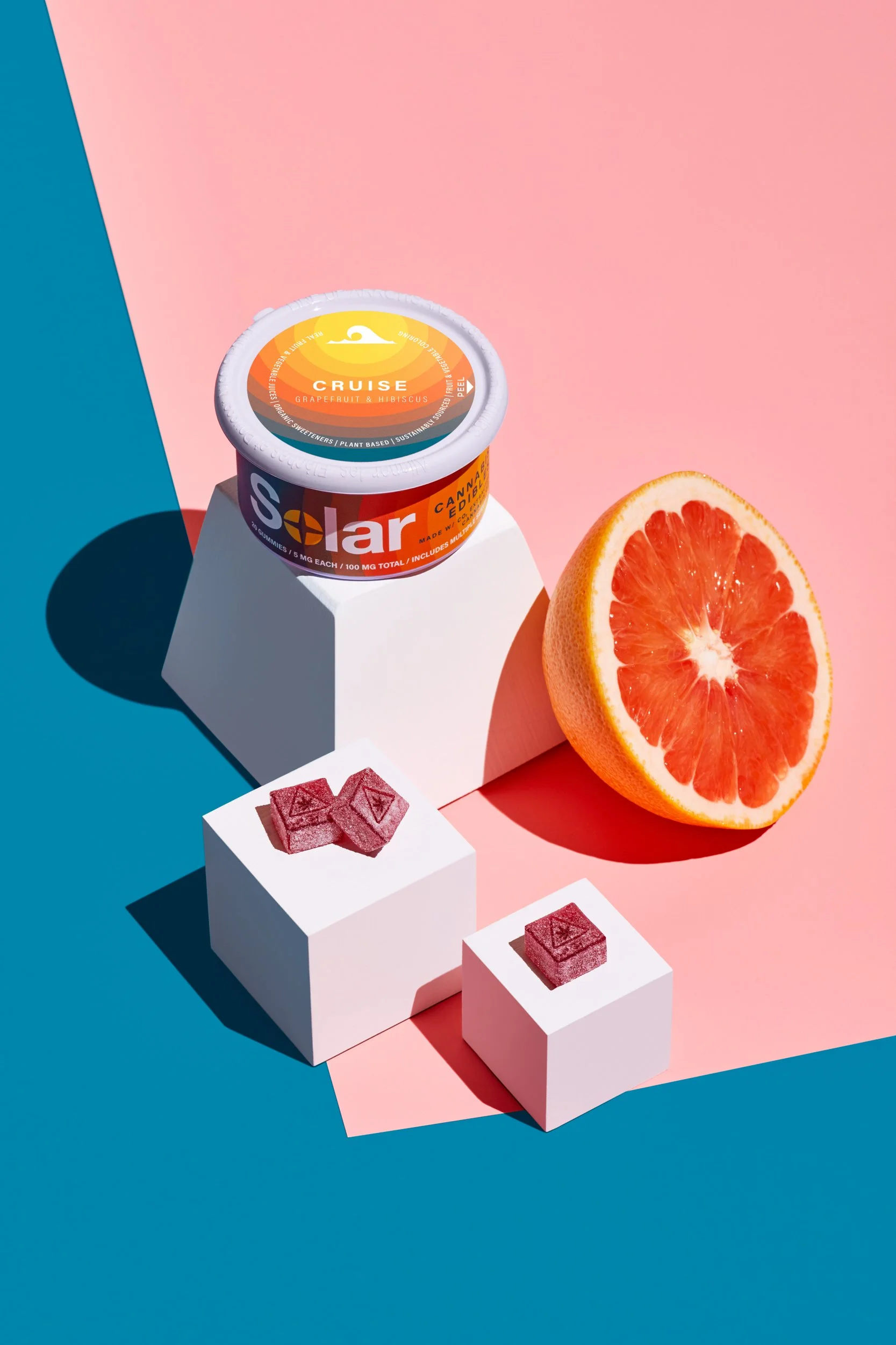 Adam Krauth Photo - Commercial Photography - Boston, MA - Still life - Product - Cannabis edibles. A colorful, geometric composition. Solar citrus-flavored gummies. A vibrant split background of pink and blue.