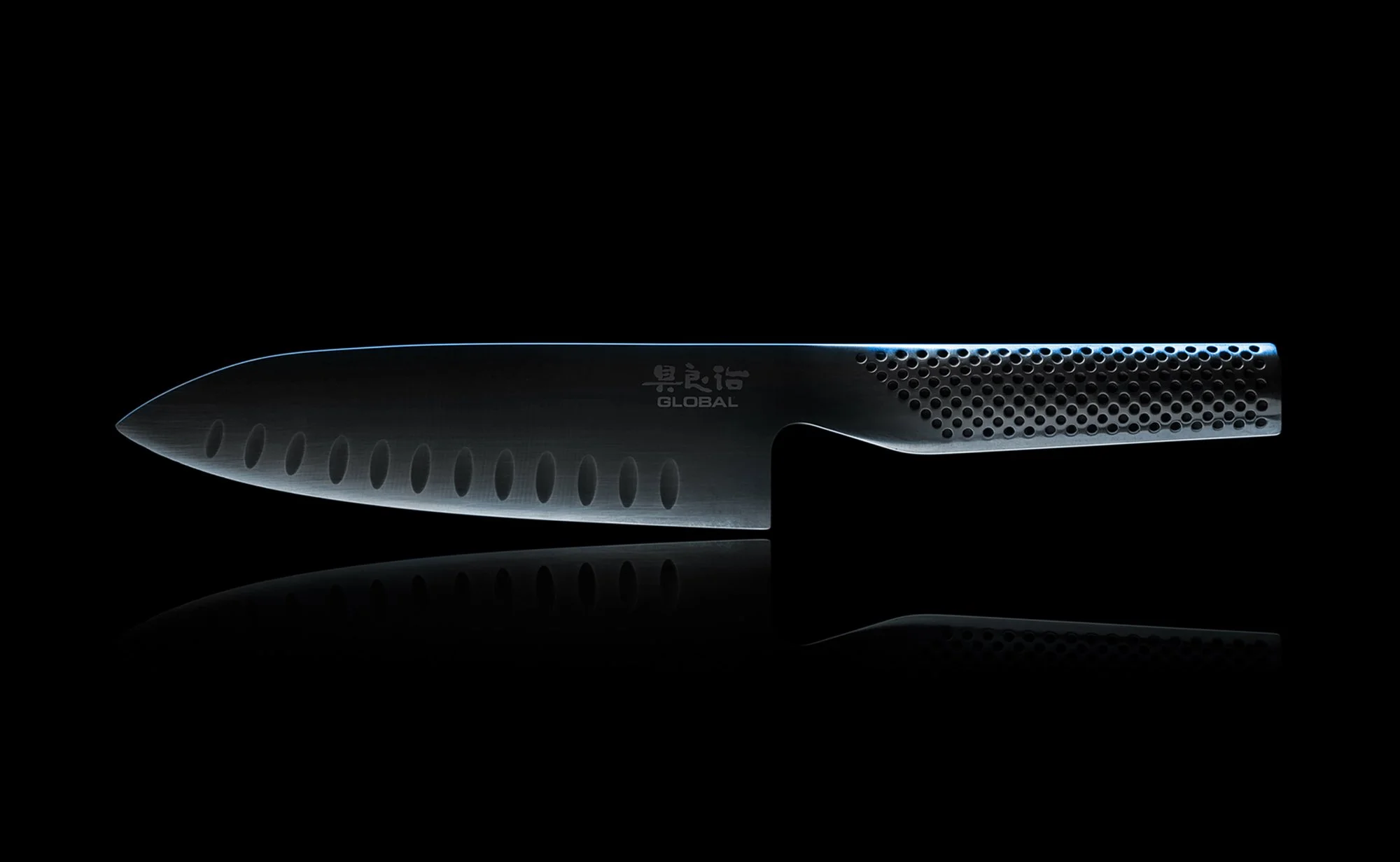 Adam Krauth Photo - Commercial Photography - Boston, MA - Still Life - Product Photography - A sleek stainless steel Global knife with a black background with subtle lighting highlighting its shape.