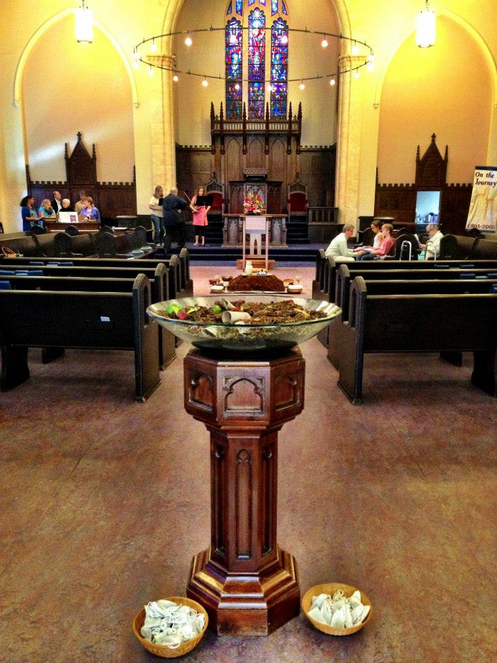 This is the font---right when you walk through the doors of the sanctuary, passing by the wheelbarrow and compost bin. The visual trajectory is to start at the wheelbarrow with initial food scraps, walk past the font with the decomposing food, and then see the compost with the fully composted materials.