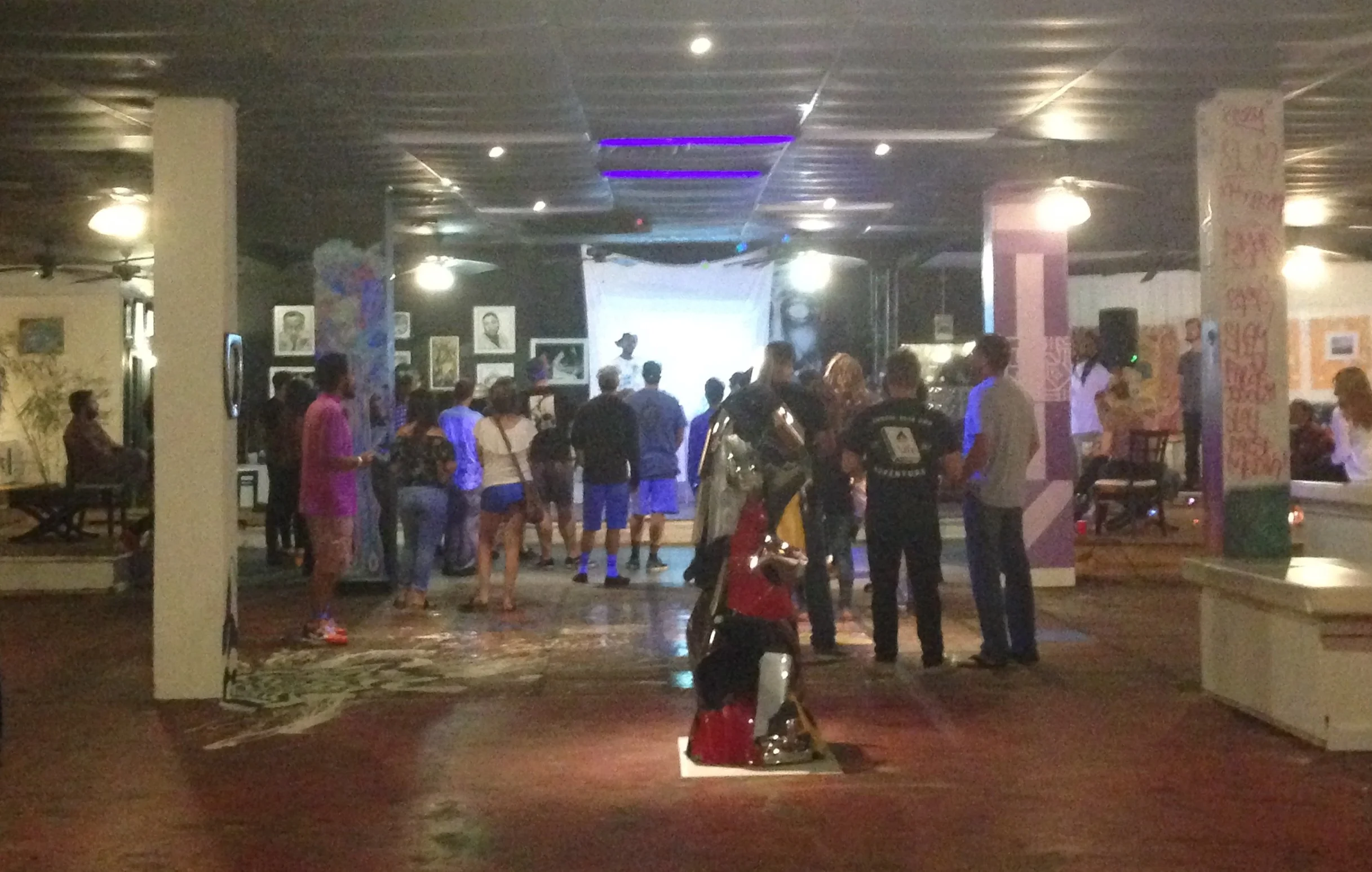 3!5 Musician/Artist/Wordsmith, Eayaes, chats with the crowd before a live performance.