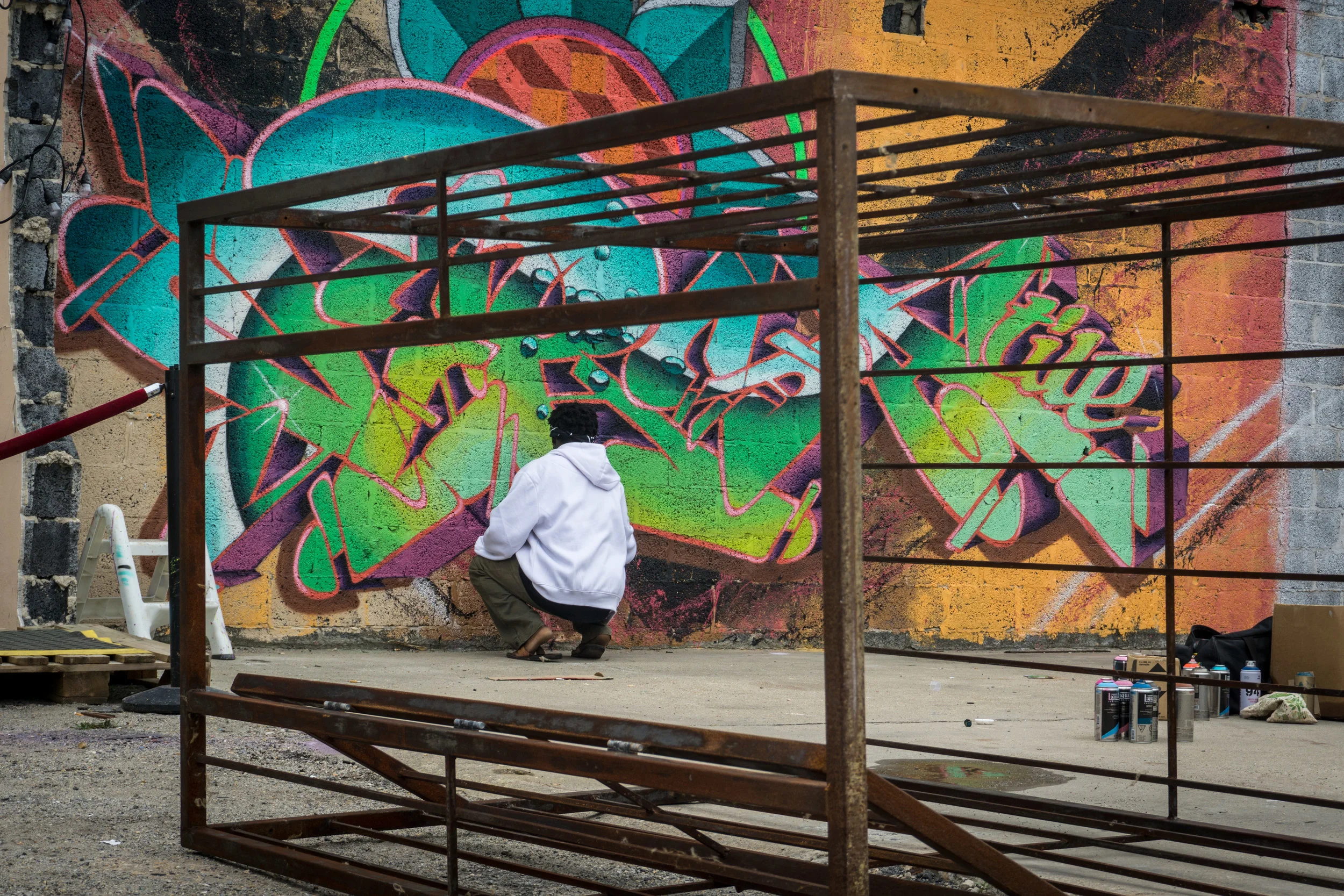 Graffiti artist, Versatile Vice (Vice Versa), brings life to a wall in the 3!5 courtyard.