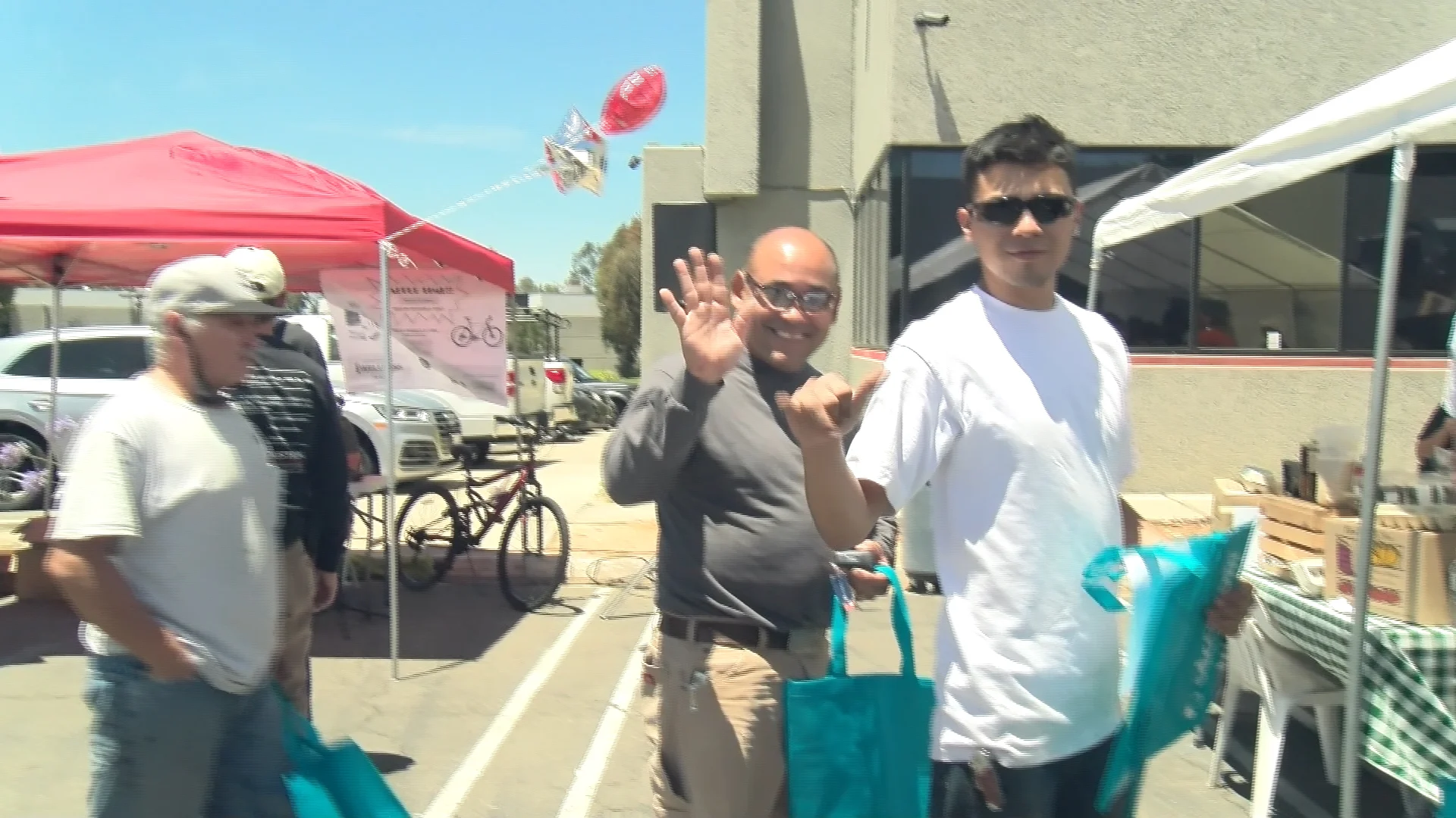Men waving to the camera.