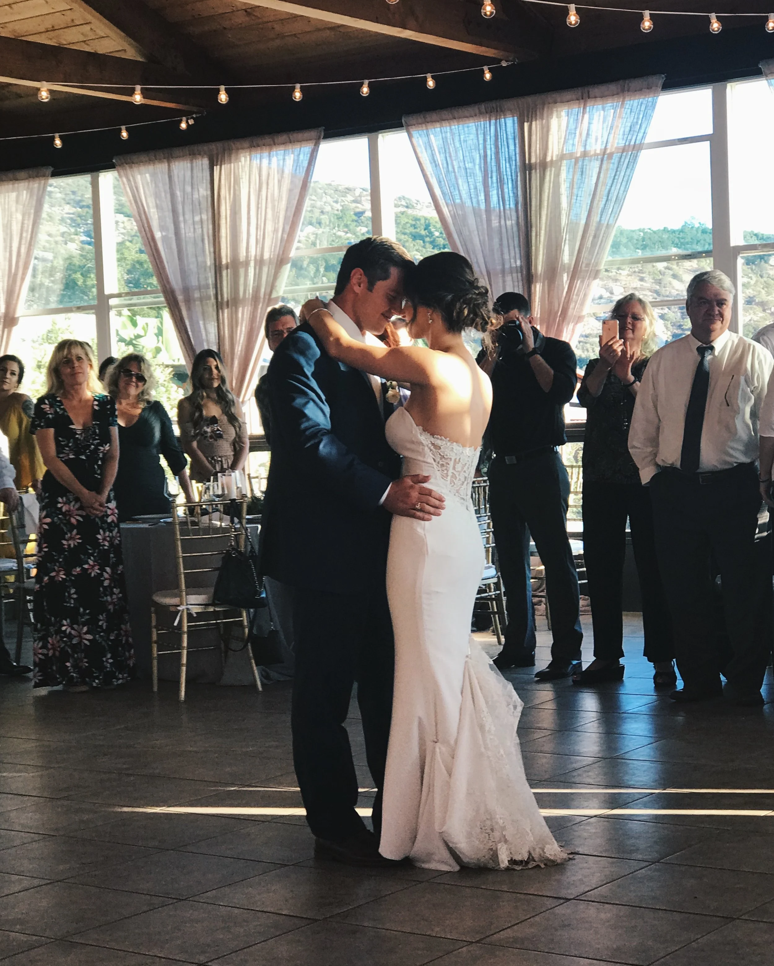 Bride and groom slow dancing on the dance floor.