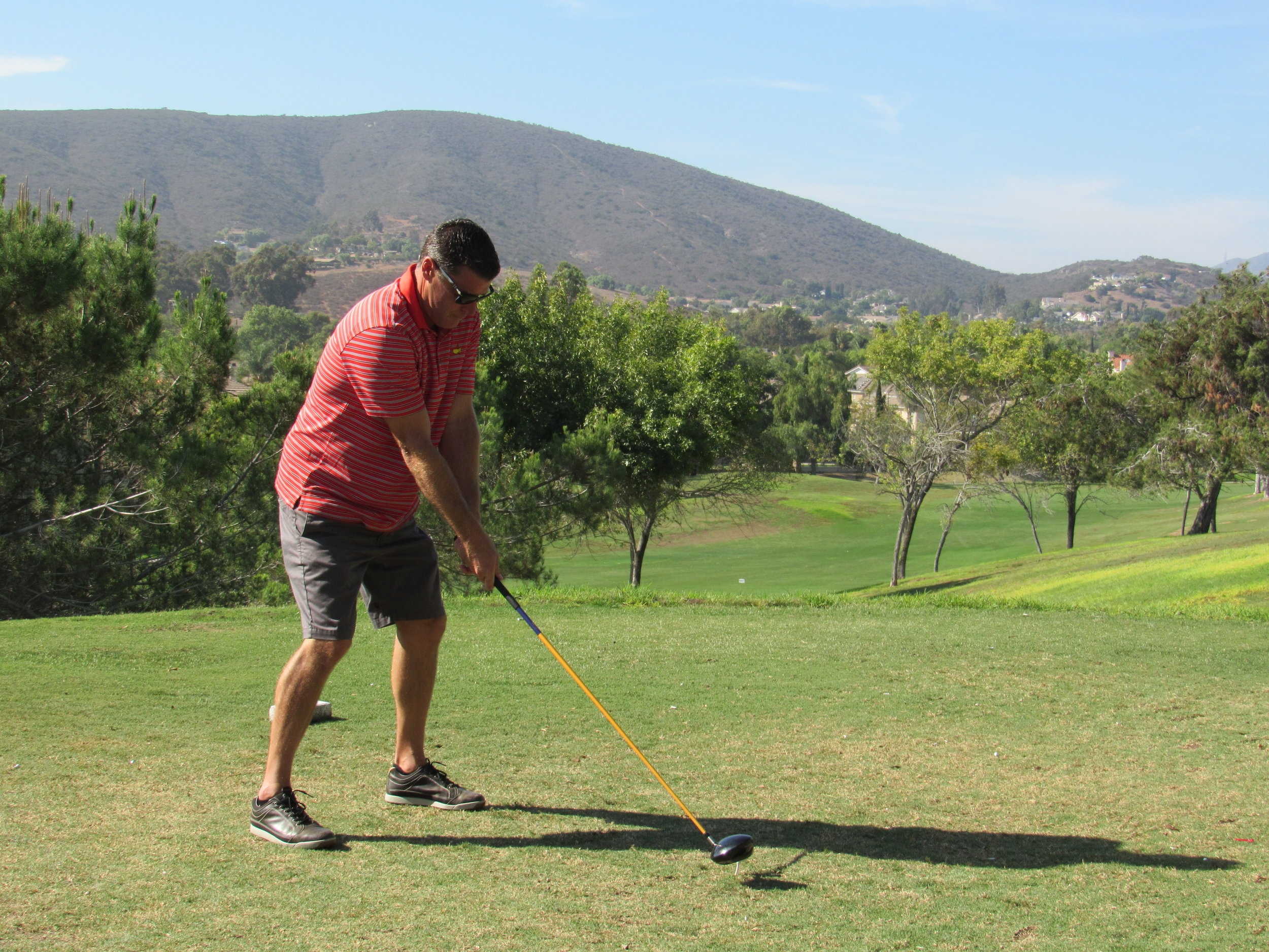 Sam Clayton preparing to swing on the golf course.