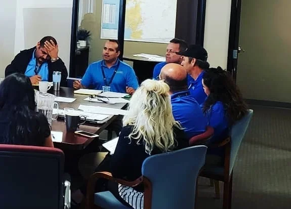 More Sunset Commercial management and ownership team sitting around a conference table.