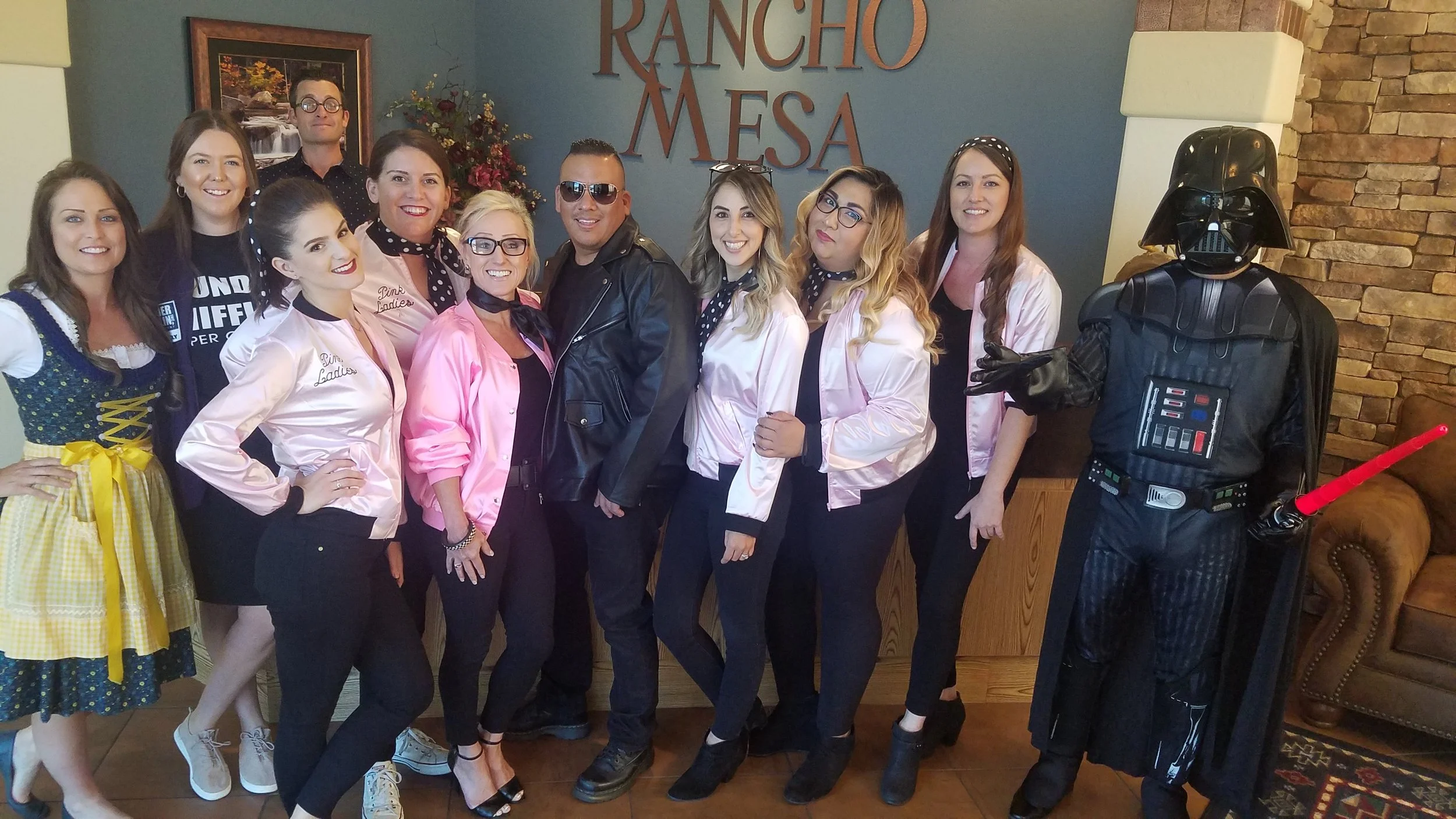 Eleven Rancho Mesa employees wearing Halloween costumes