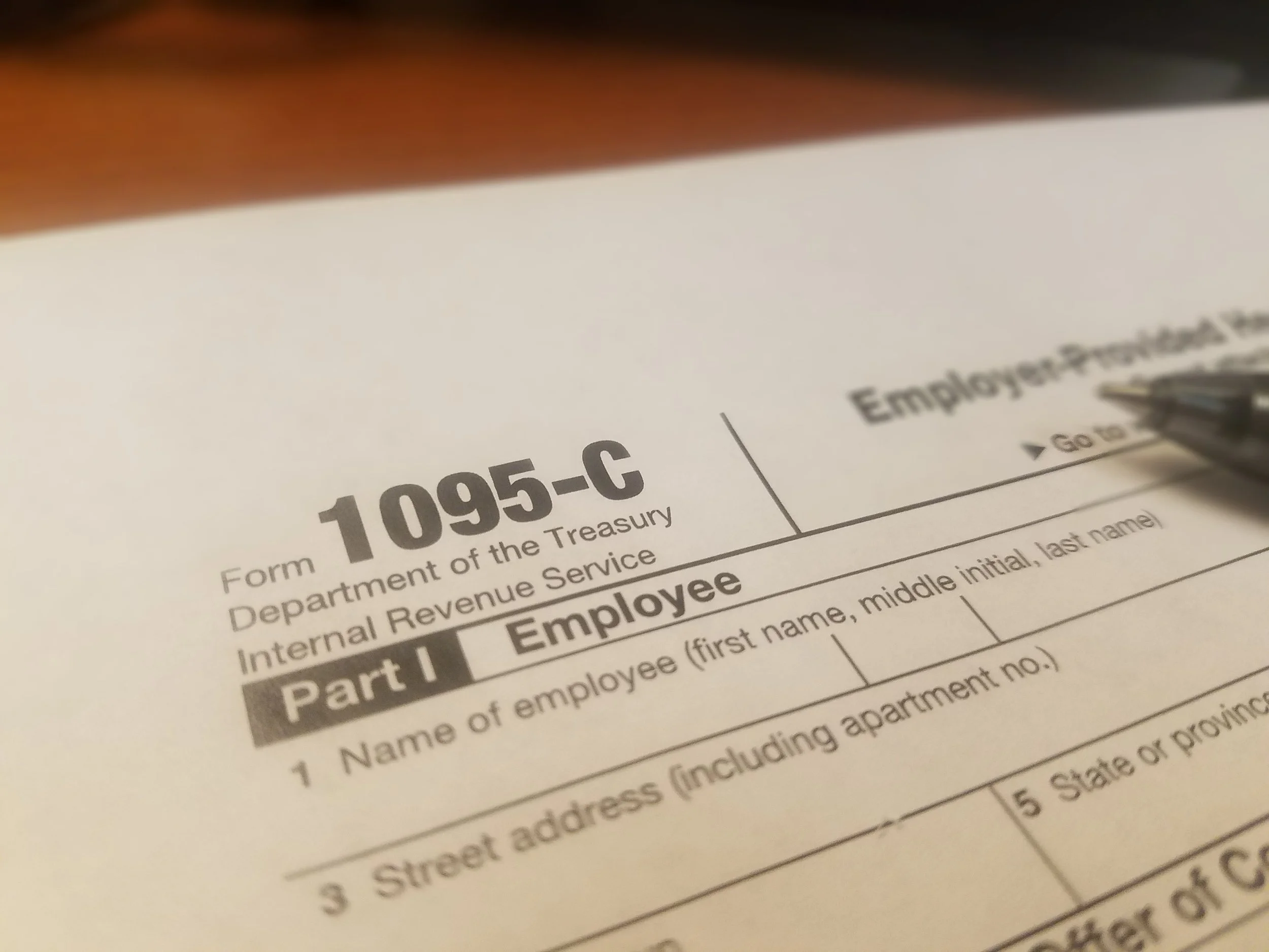 1095-c Form and pen.