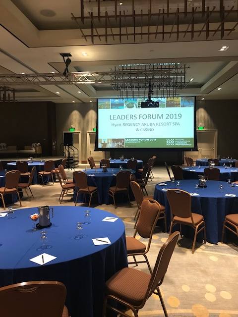 Empty ball room at the Leaders Forum with a giant screen