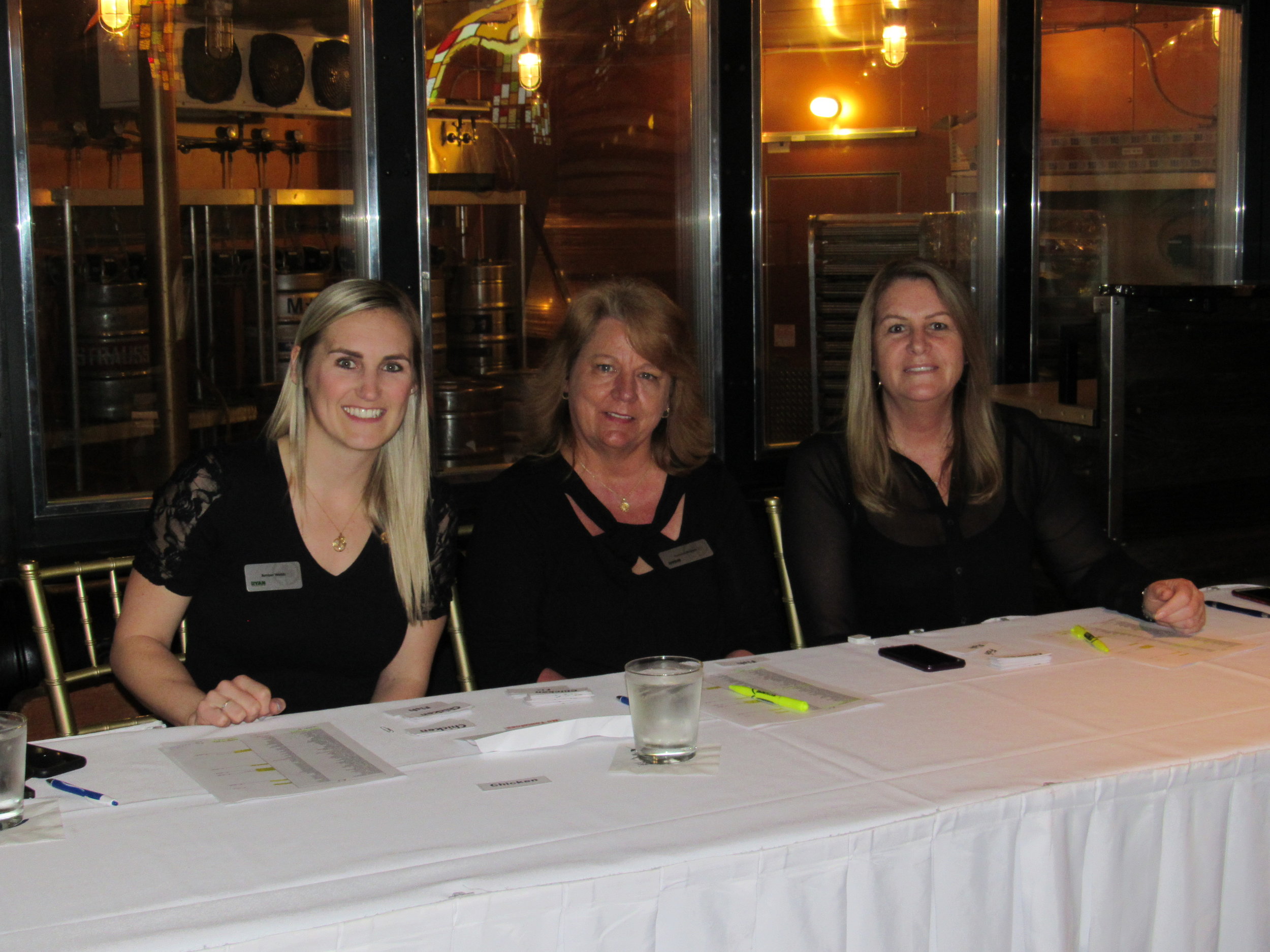 Amber Webb and two ladies sitting at registration table