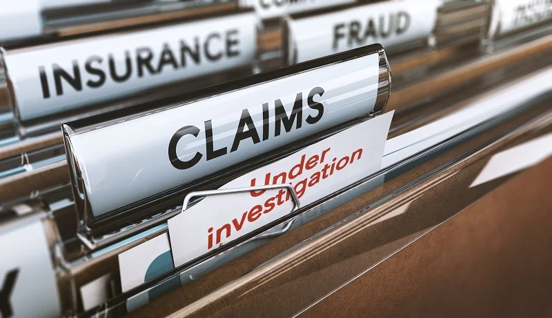 Image of files with the title “Claims” and a “Under Investigation” in red letters appearing out of the folder.