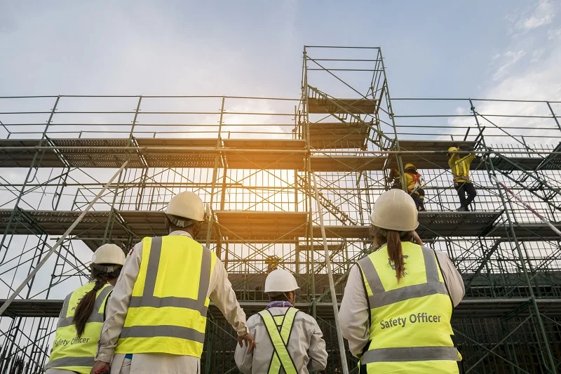 Image of Safety Officer and workers inspecting scaffolds.