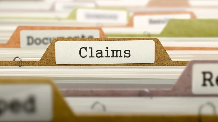 Image of folders filed and focused on a folder titled “Claims”