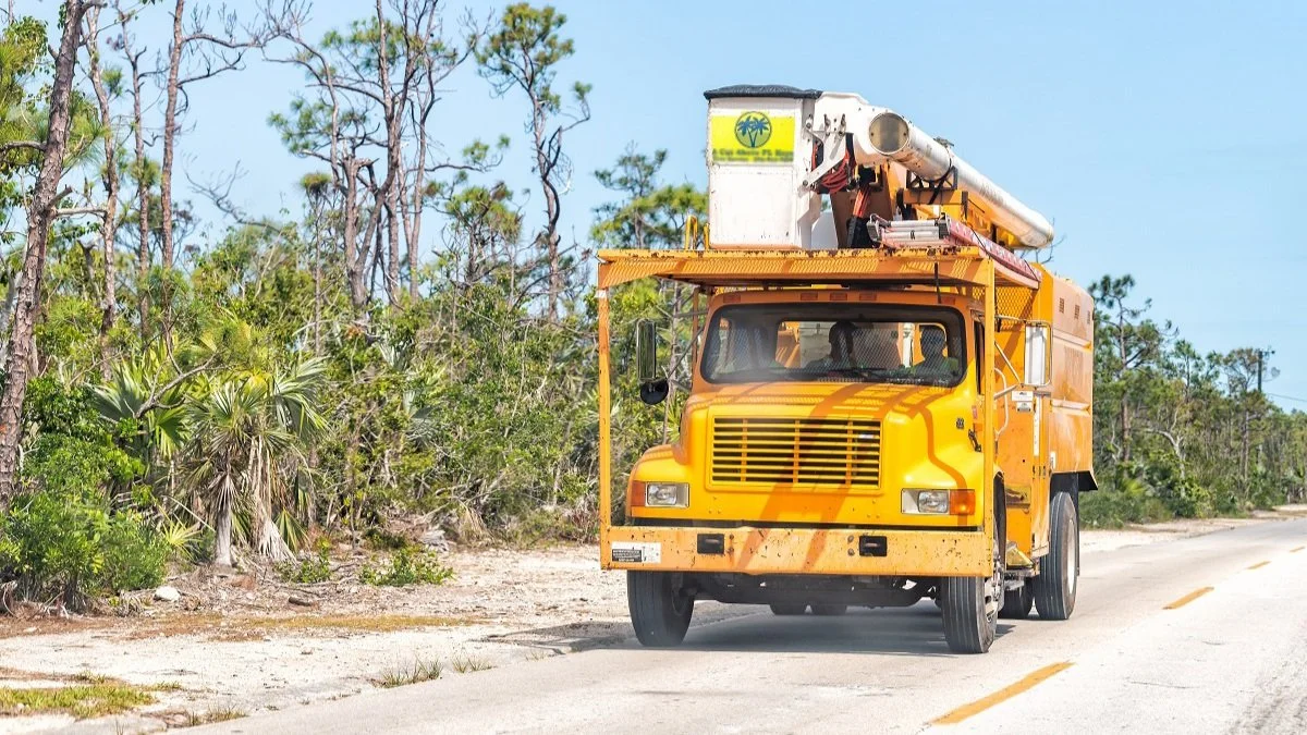 Tree Trimming Truck Driving Down Road.jpg