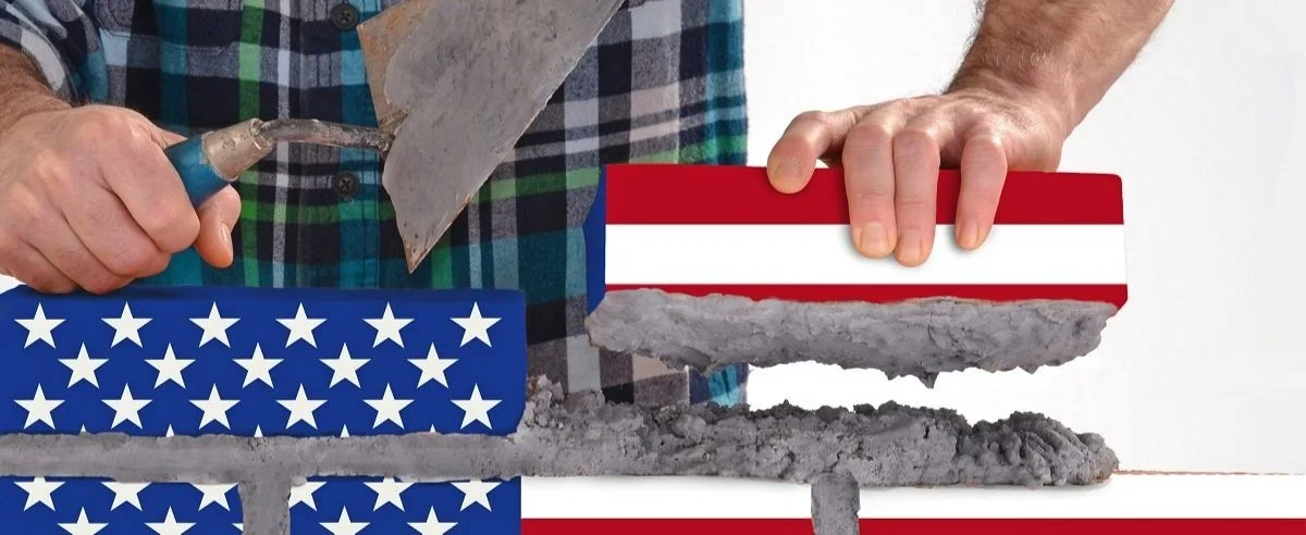 Man stacking brick wall of American Flag design.jpg