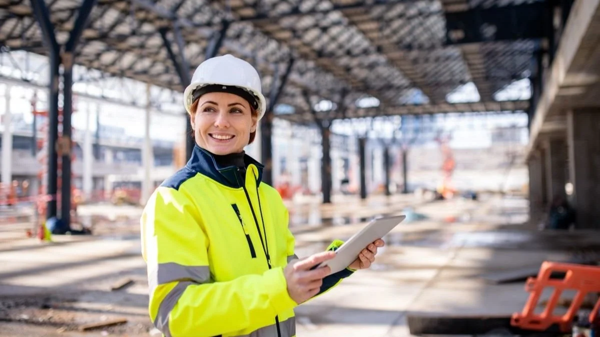 Women construction worker standing on construction site holding tablet.jpg