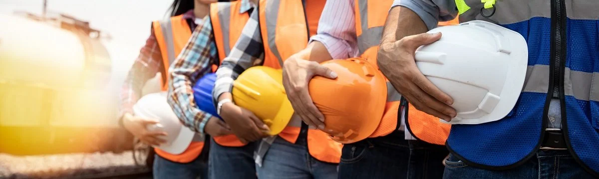 Construction Workers Holding Helmets.jpeg