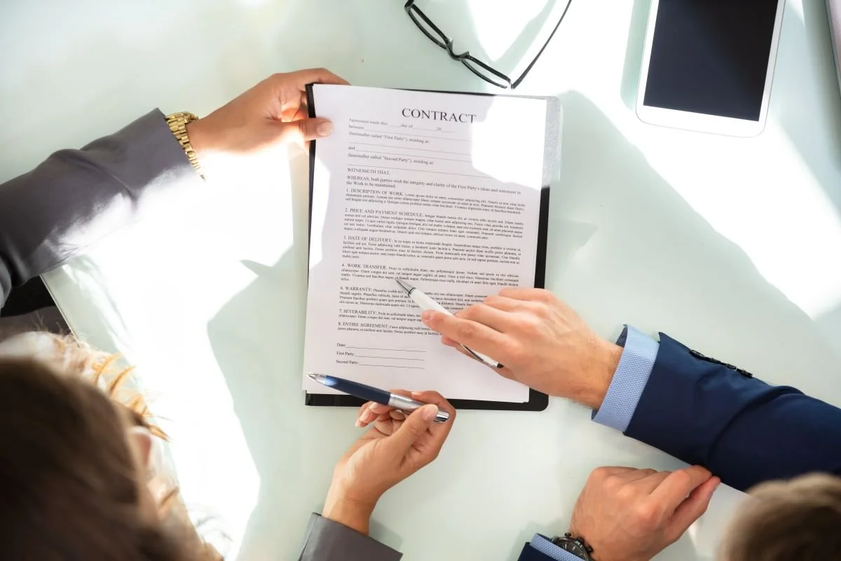 Two Businesspeople Working On Contract Paper (1200 pixels).jpg