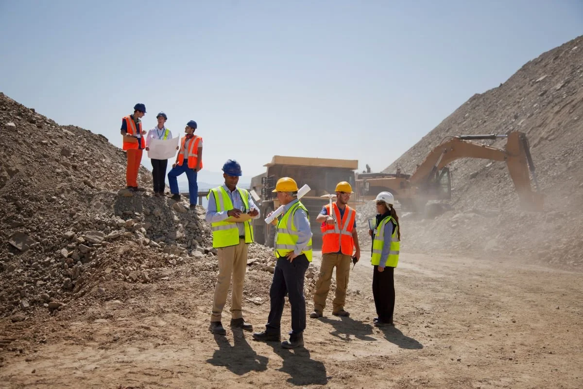 Business people and construction workers talking in jobsite.jpg