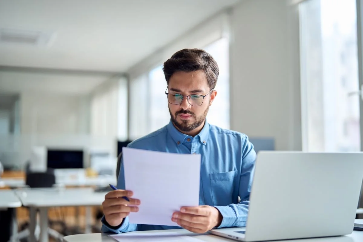 Professional business man checking document at desk in office.jpg