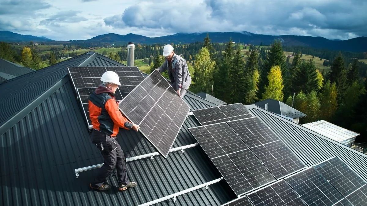 Workers building solar panel system on roof of house.jpg