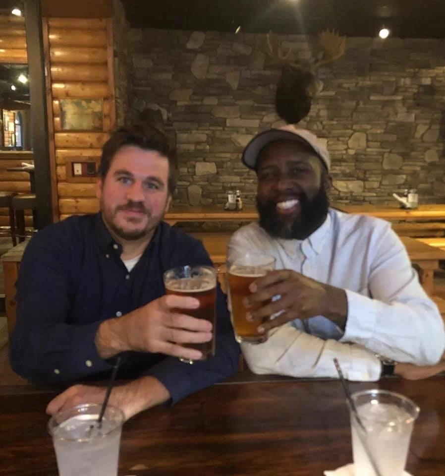 Attorney Jack schulz shares a beer with client tracy evans after resolving his lawsuit against founders brewery.  evans case, which alleged that he was terminated for standing up against a racially hostile work environment at the country’s largest c…
