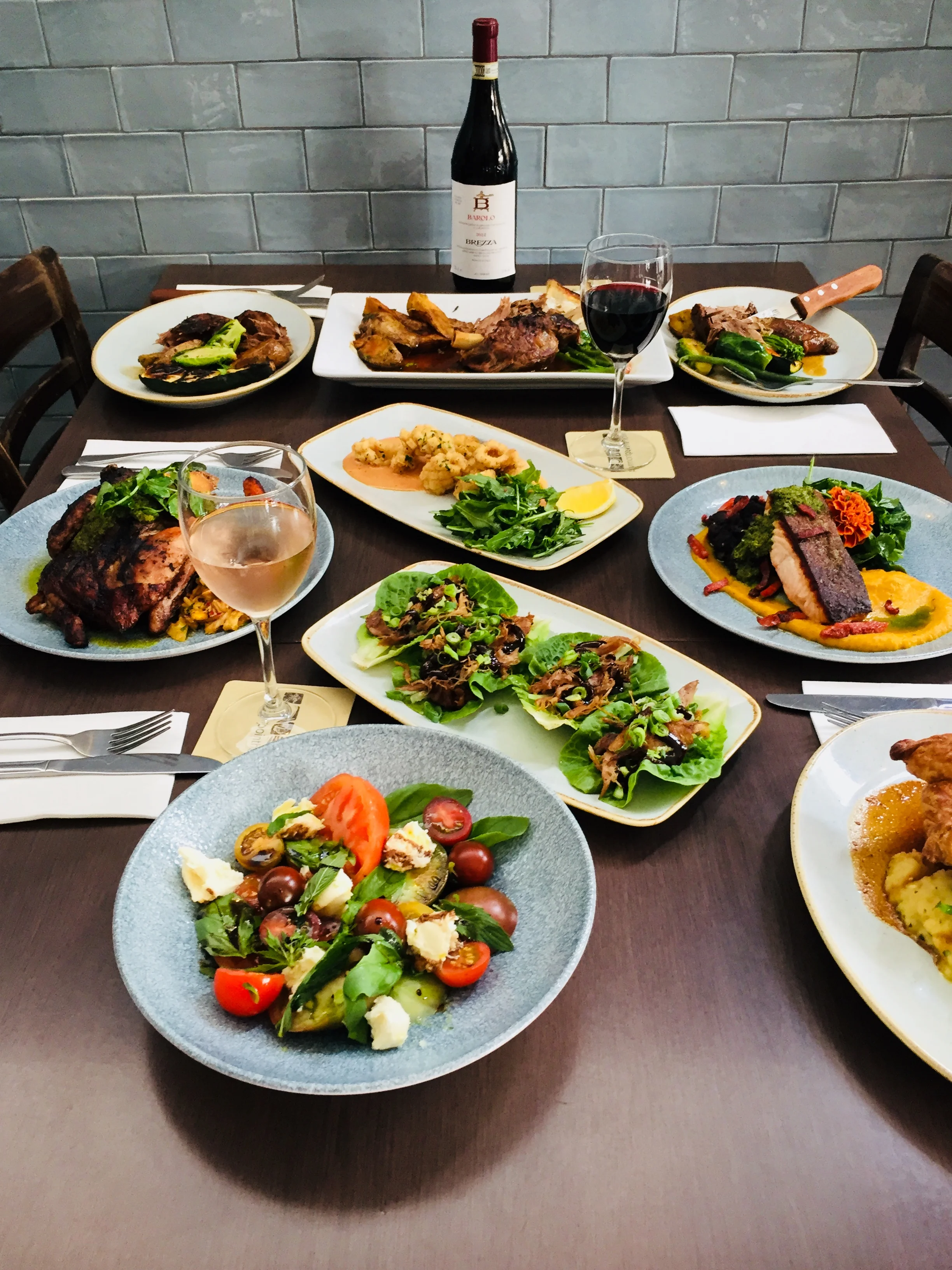 HERE ARE A FEW EXAMPLES OF RHYS 'HANDIWORK. PHOTOGRAPHED CLOCKWISE; SUCCULENT SLOW ROASTED LAMB SHOULDER FOR TWO WITH ALL THE CLASSIC TRIMMINGS PAN SEARED TASMANIAN SALMON WITH MOROCCAN SPICED PUMPKIN & SWEET POTATO PUREE, GRILLED CHORIZO AND MARIGOLD FLOWERS PULLED PEKING DUCK SAN CHOY BOW SWEET AUSTRALIAN BASIL, HEIRLOOM TOMATO & BOCCONCINI CAPRESE SALAD JERK WHOLE SPATCHCOCK WITH HERB ROAST CARROTS, JUS AND JAMAICAN SLAW ROCK SALT & SZECHUAN DUSTED SQUID