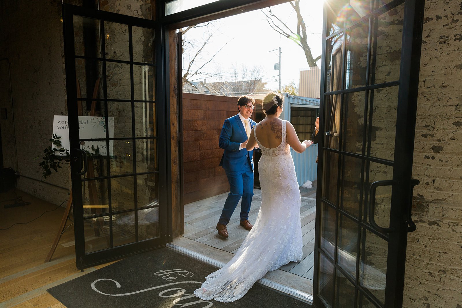  Candid, documentary photo of the couple exiting their nontraditional Jewish and Venezuelan wedding ceremony in the round at The Joinery Chicago an Industrial loft wedding venue In Logan Square. 