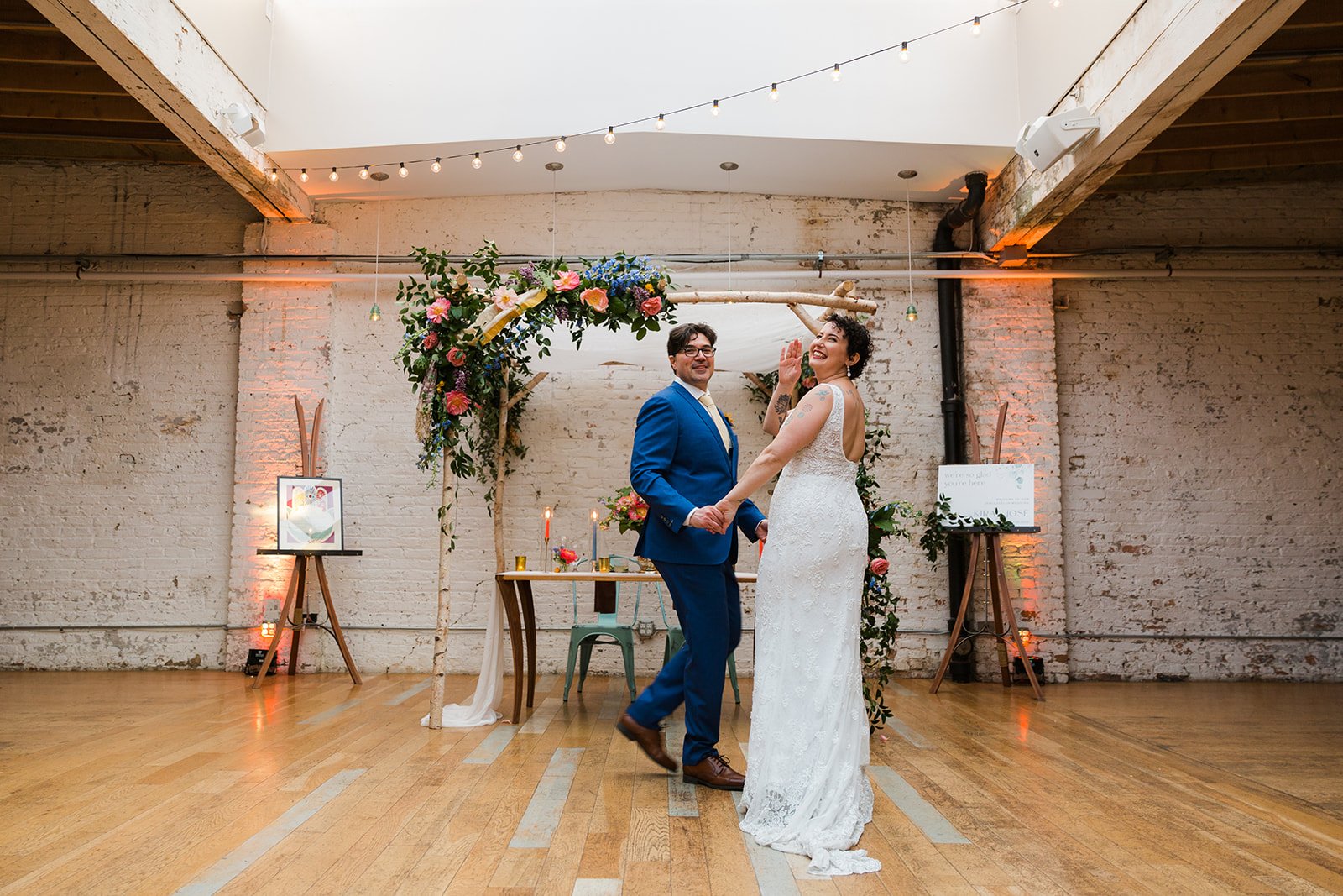  Documentary candid photo of bride and groom during first dance nontraditional Jewish and Venezuelan wedding at The Joinery Chicago an Industrial loft wedding venue In Logan Square.  