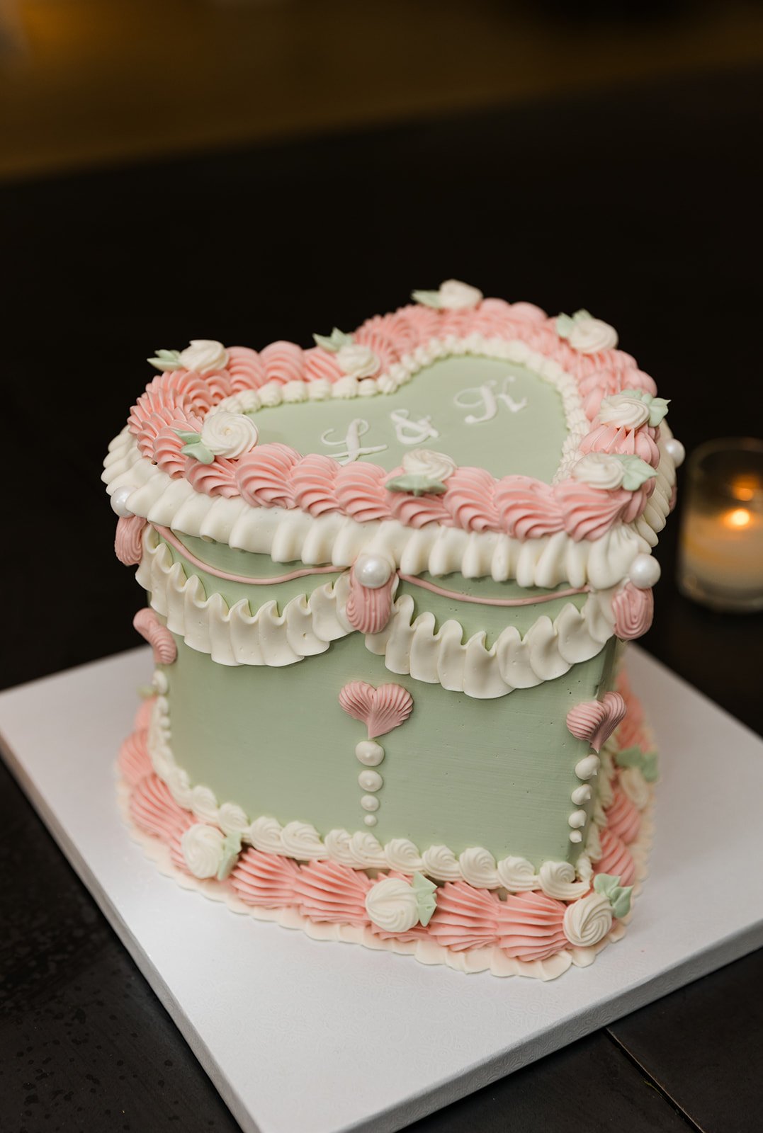Pink, green and white heart shaped vintage wedding cake decor at Greenhouse Loft