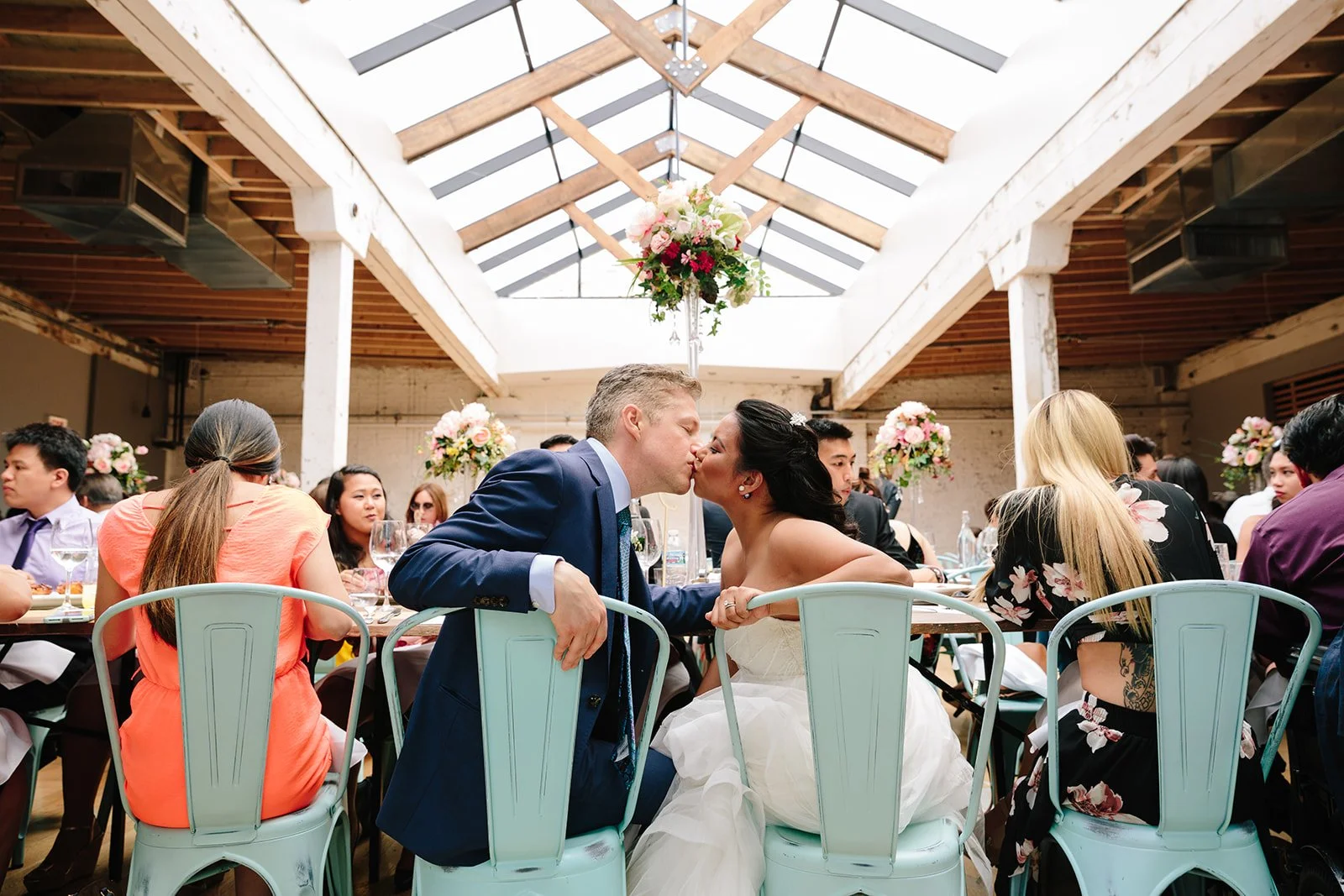 Couple kissing at wedding reception 