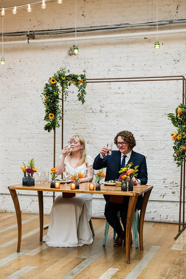 Couple cheers at their wedding reception the joinery 