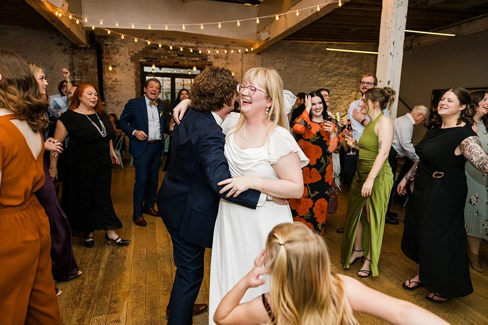 candid of bride and groom on dance floor 