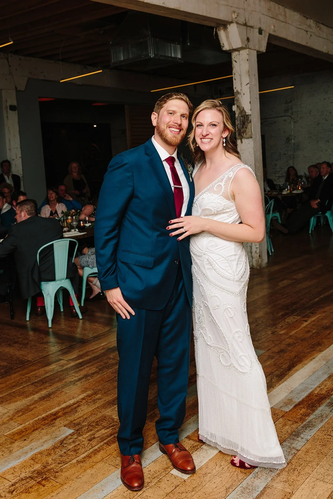 Bride and groom smiling for camera on wedding dance floor