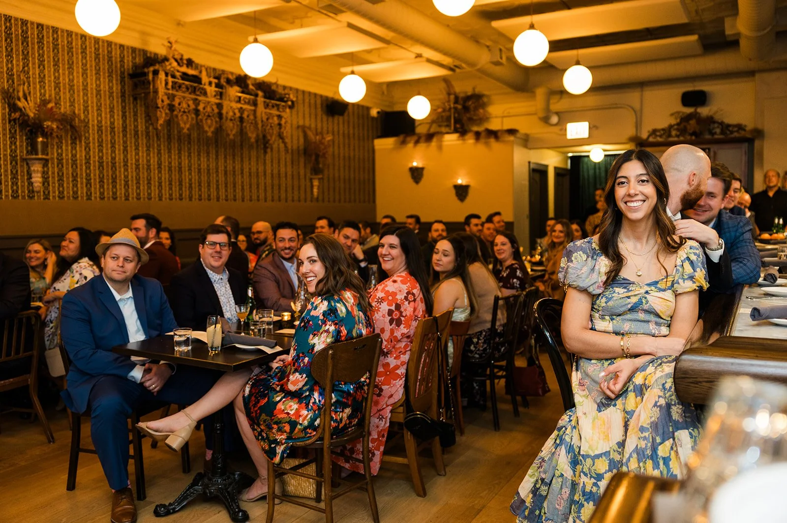  Documentary style candid photo of guests enjoying the reception dinner at Segnatore for tan intimate restaurant wedding in Humboldt Park Chicago  