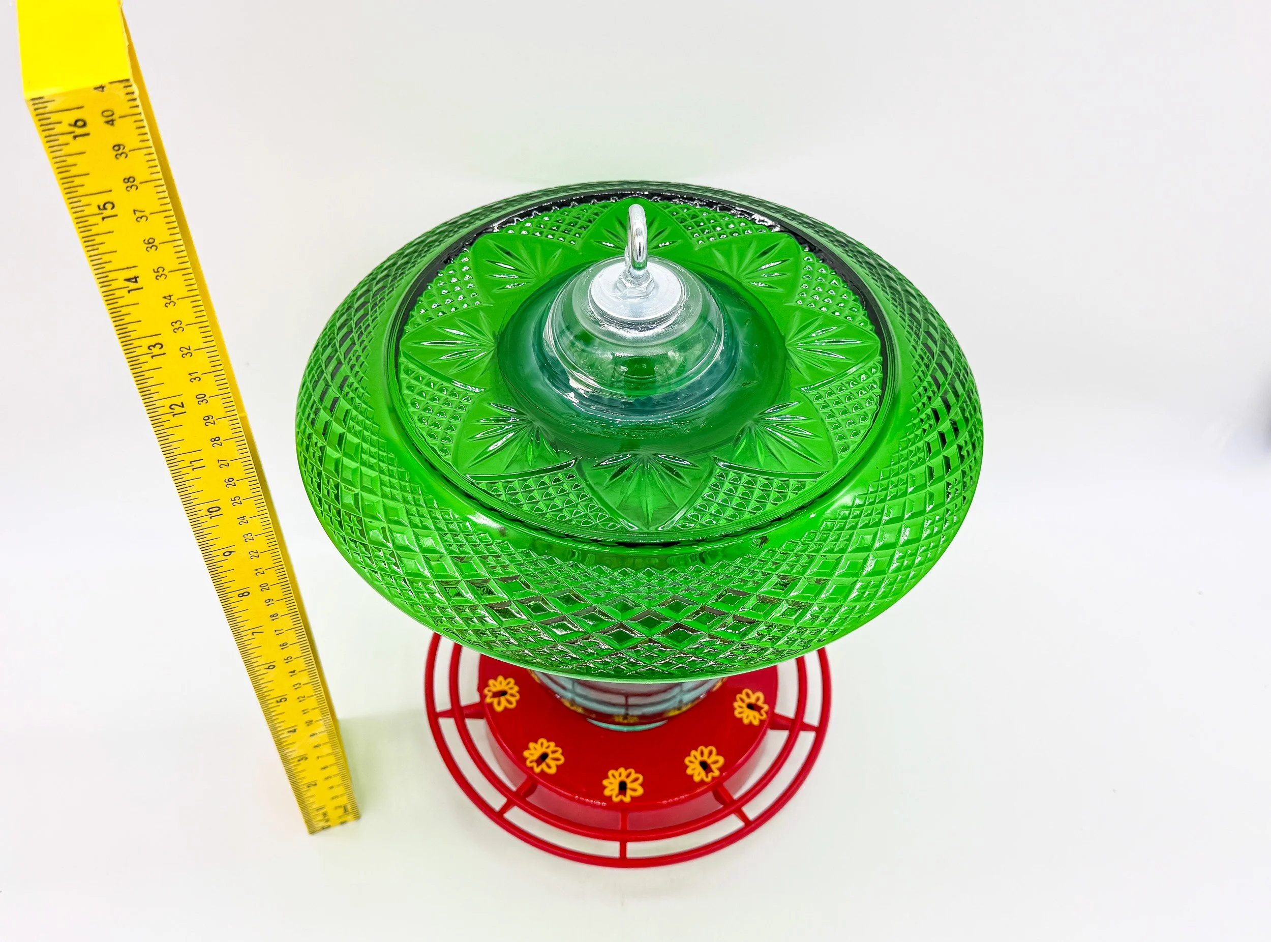 Decorative green plate hummingbird feeder with antique mason jar