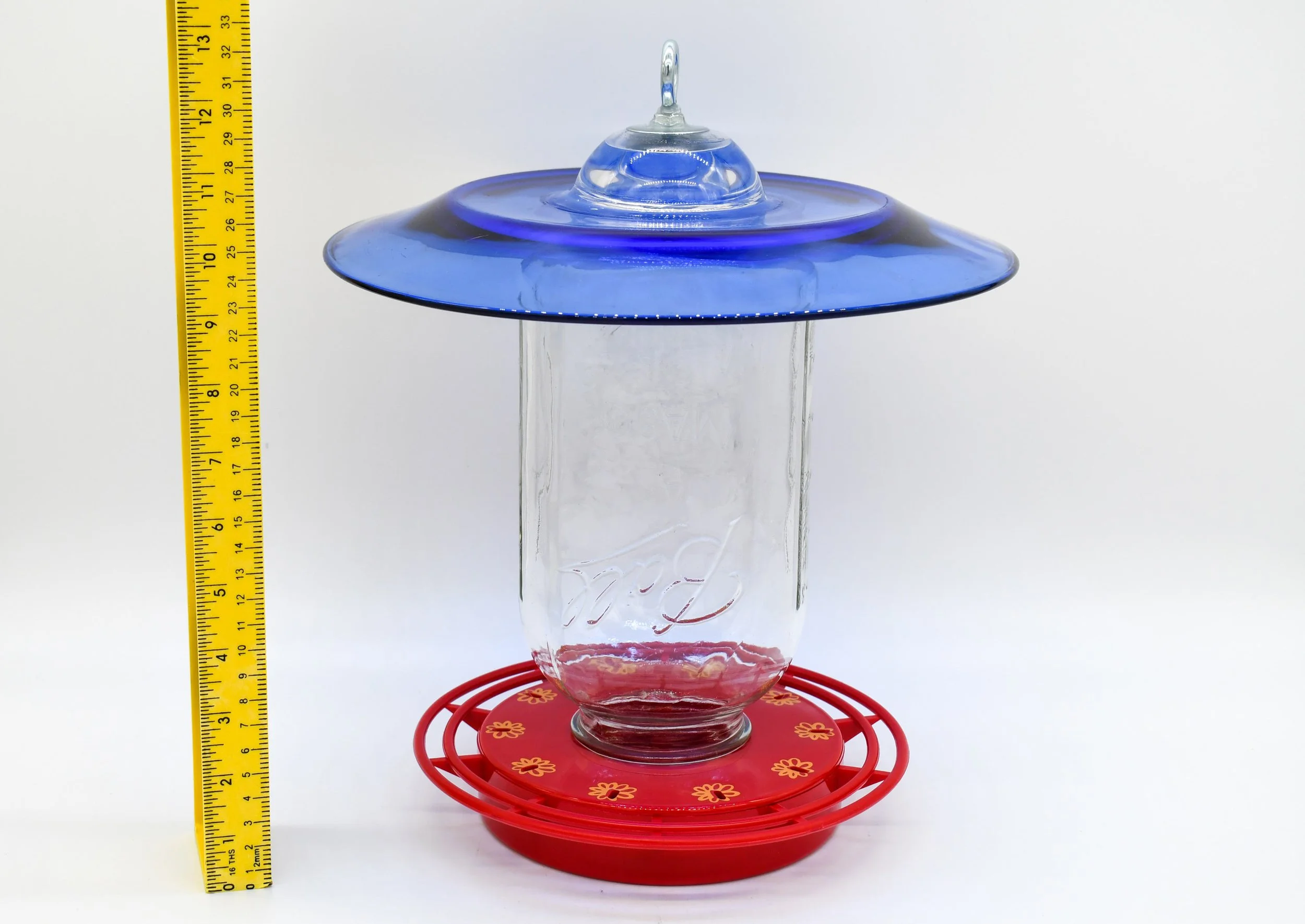 Side view showing the height and profile of the 64 oz cobalt glass hummingbird feeder.
