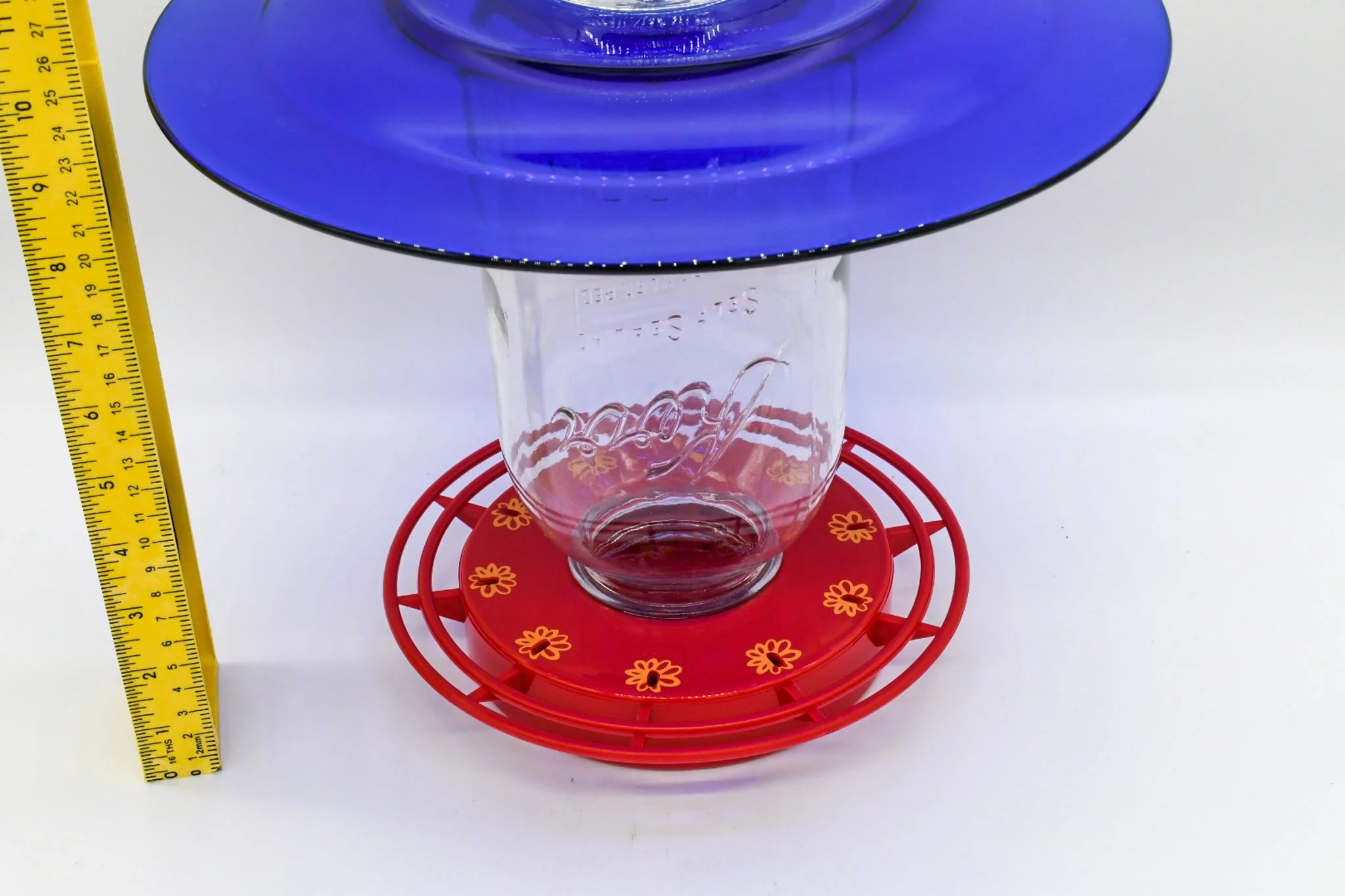 Close-up of the 64 oz Mason jar reservoir and red Turbine hummingbird feeder base.