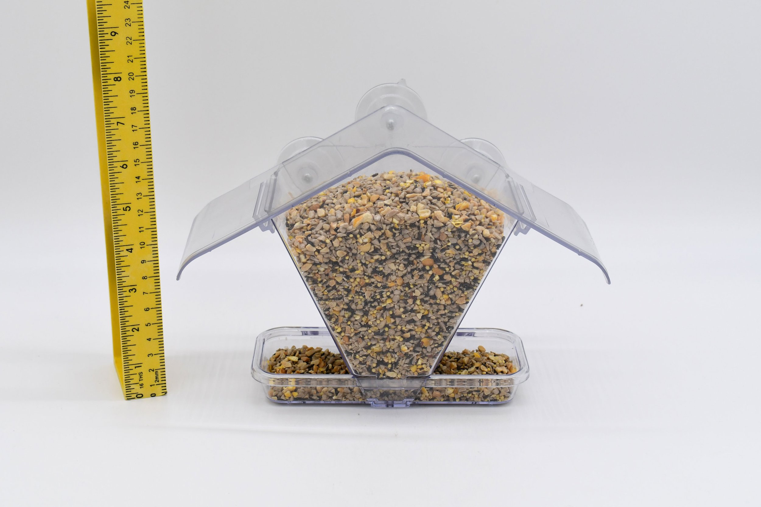 Front view of the Aspects #155 Window Cafe bird feeder filled with seed, showing its clear protective roof, seed reservoir, and feeding tray.