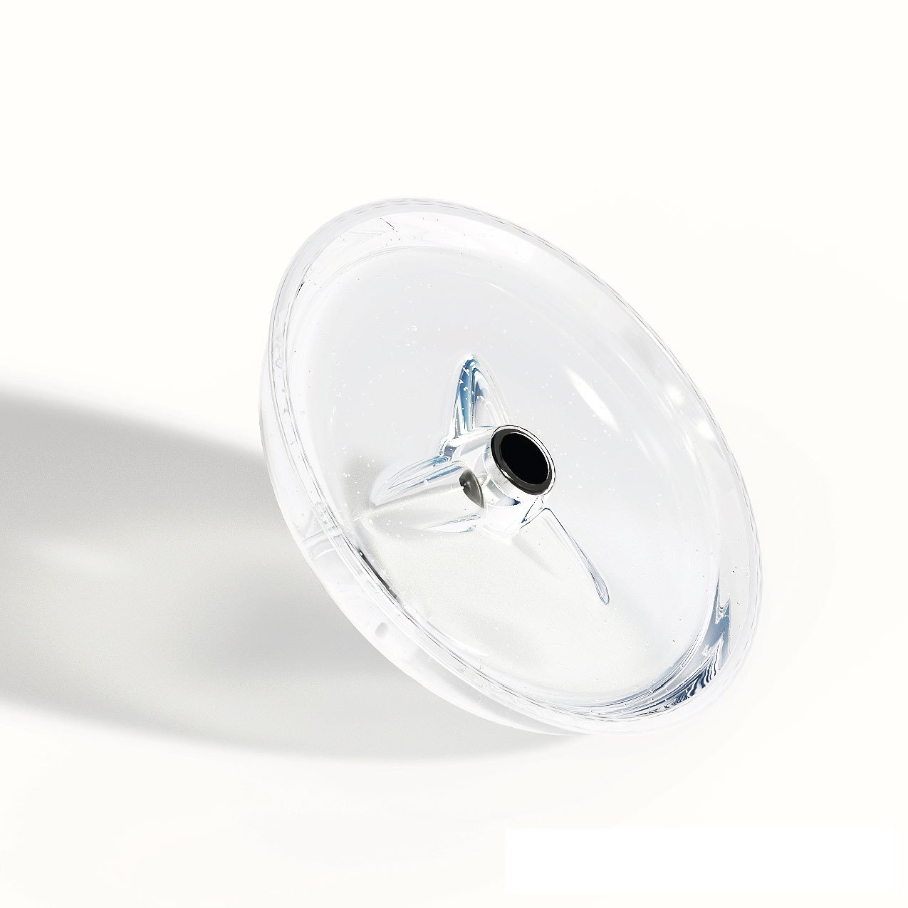Angled view of the clear Ant-Mote showing its center pole opening and molded support ribs.